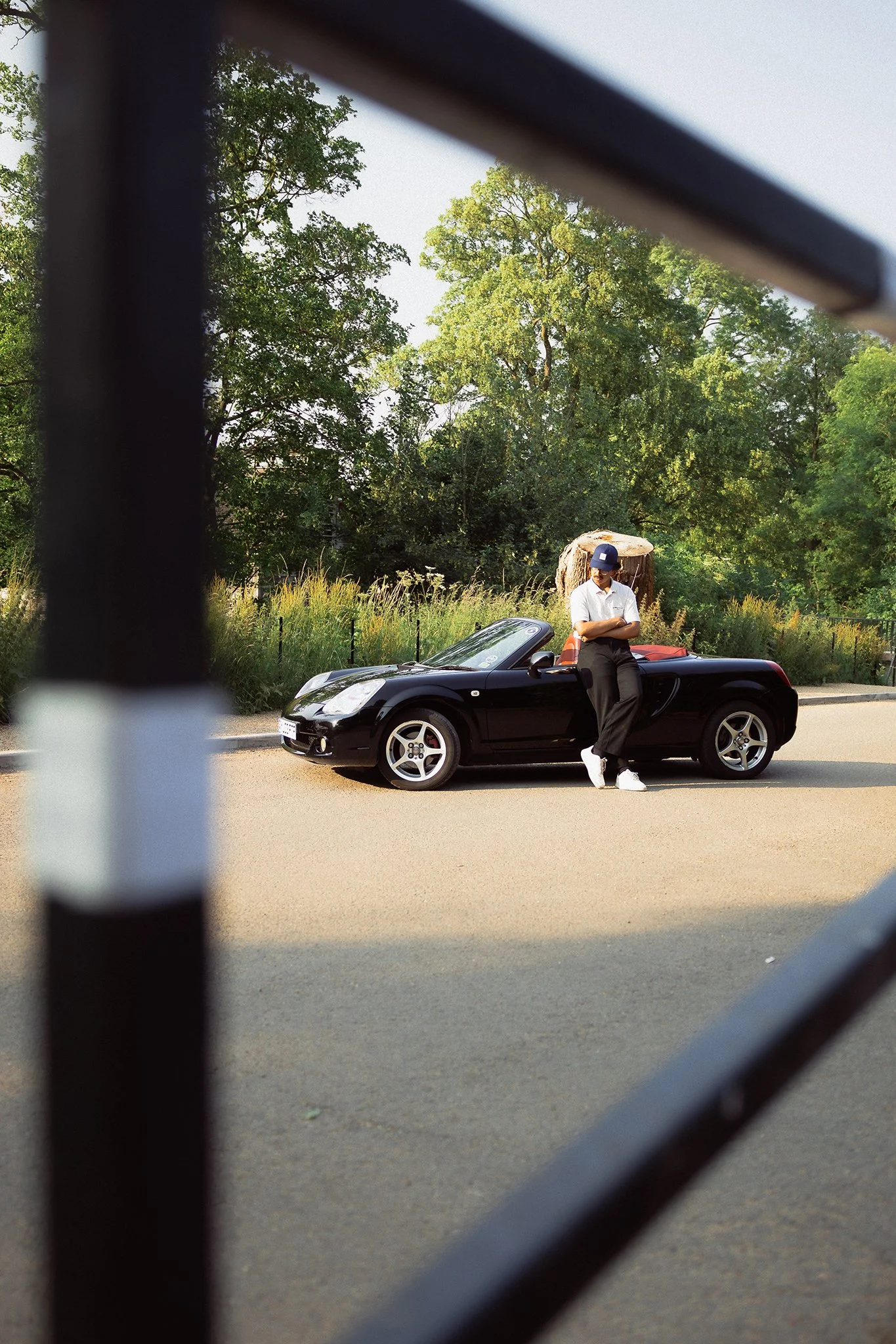 A Mazda MR2 and its owner in the summer sun