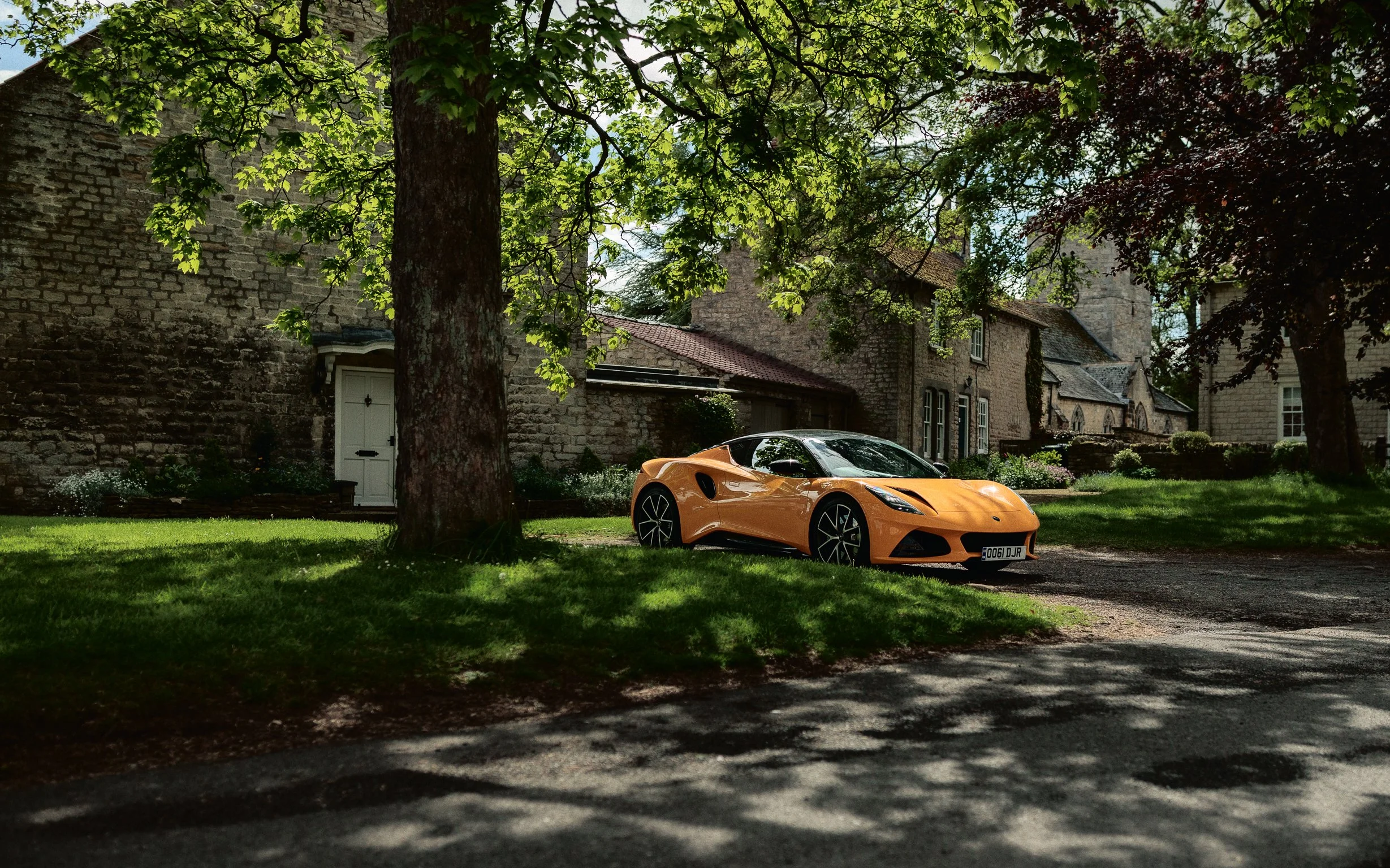 A yellow Lotus Emira hiding in the shade of a picturesque village