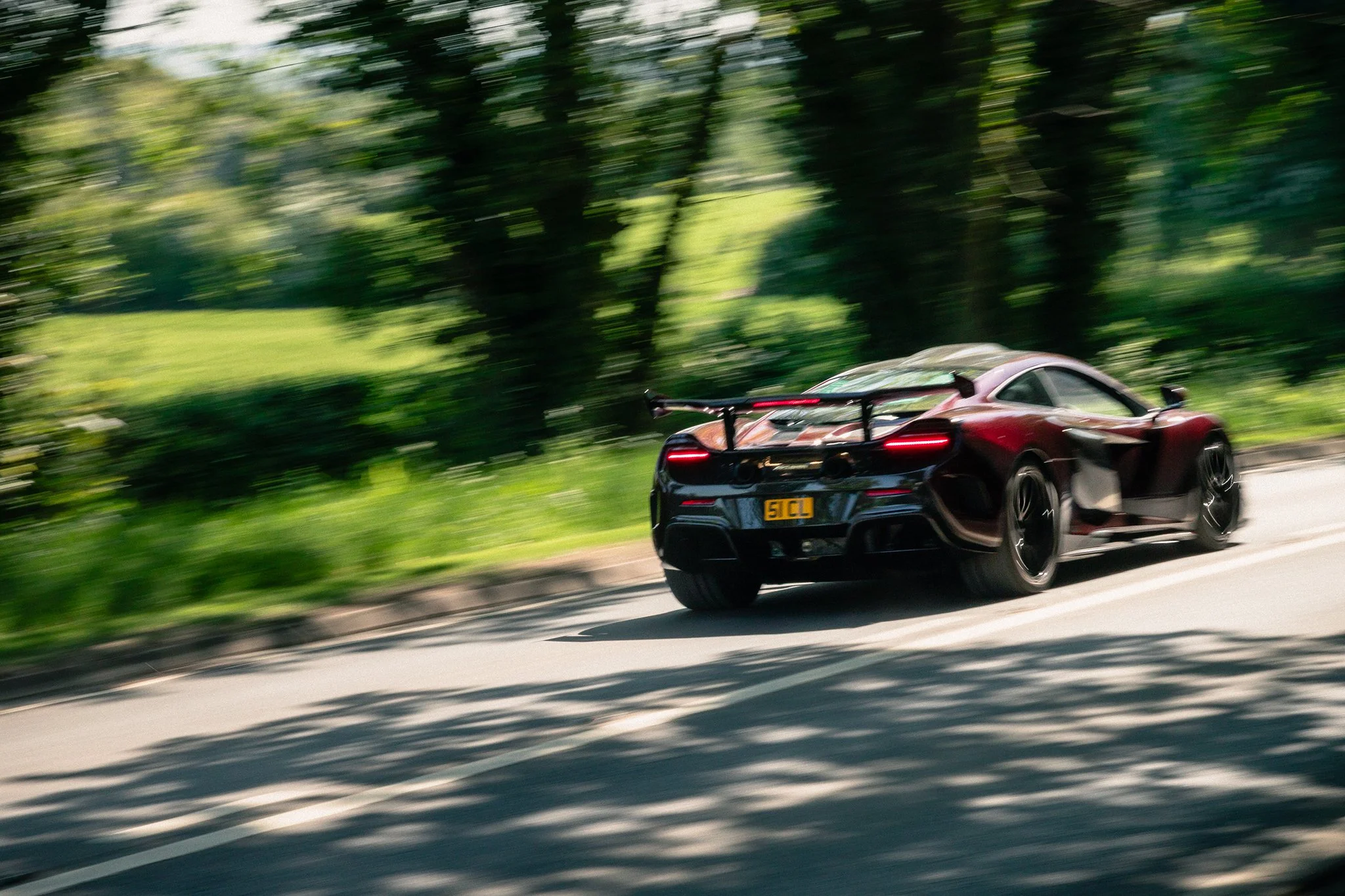 A McLaren MSO HS supercar speeds off into the distance