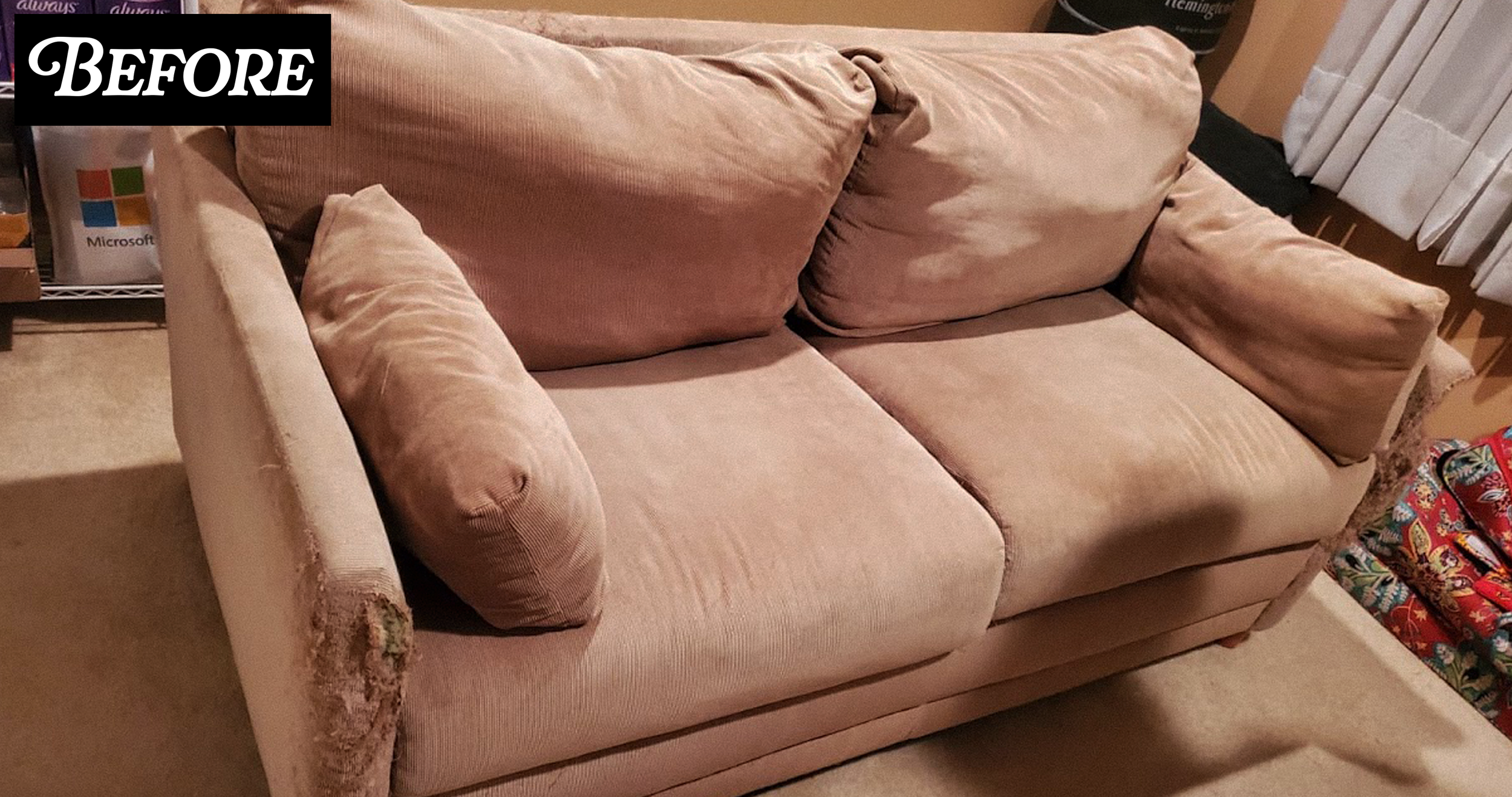 Pink fabric sofa with worn, frayed arms and cushions, located in a room with a white window blind and colorful wrapped presents on the floor.
