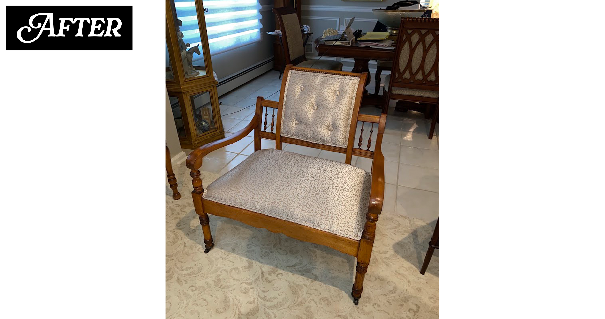 A wooden armchair with beige patterned upholstery in a room with a tiled floor, a rug, a glass-front cabinet, and a dining table with chairs. There is a window with blue horizontal blinds in the background.