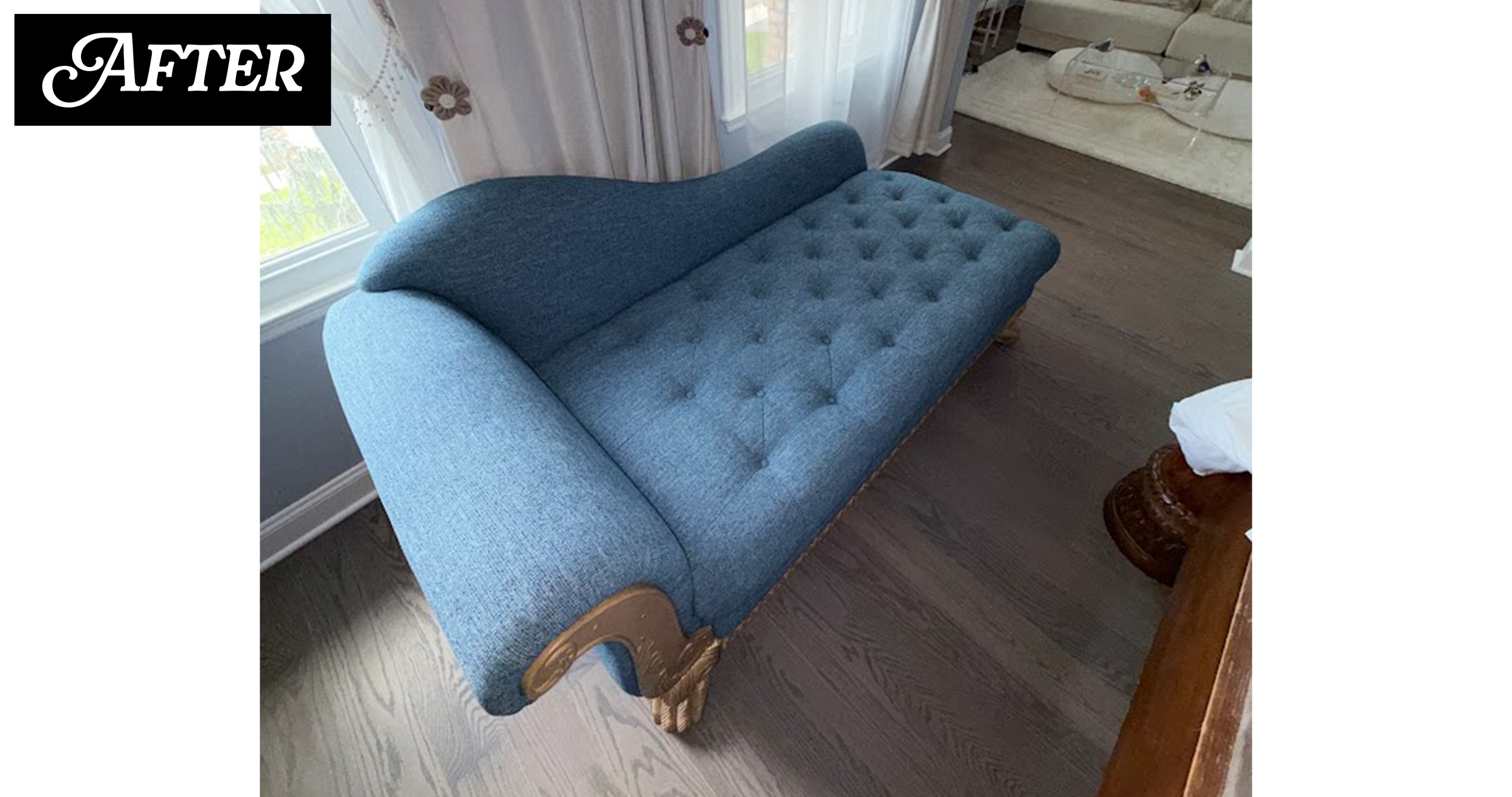 Blue upholstered vintage-style sofa with curved wooden armrests and carved wooden legs in a living room with dark hardwood flooring.