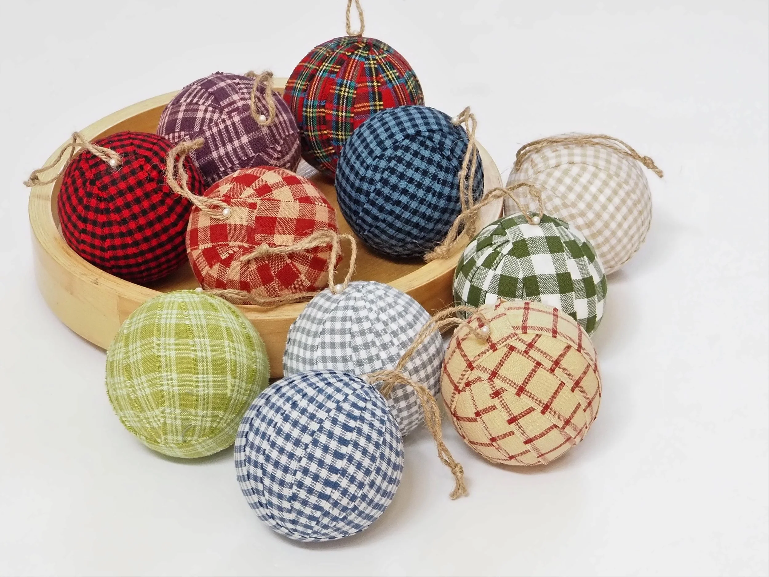 Assorted handmade woven cotton plaid holiday ornaments in decorative bowl centerpiece