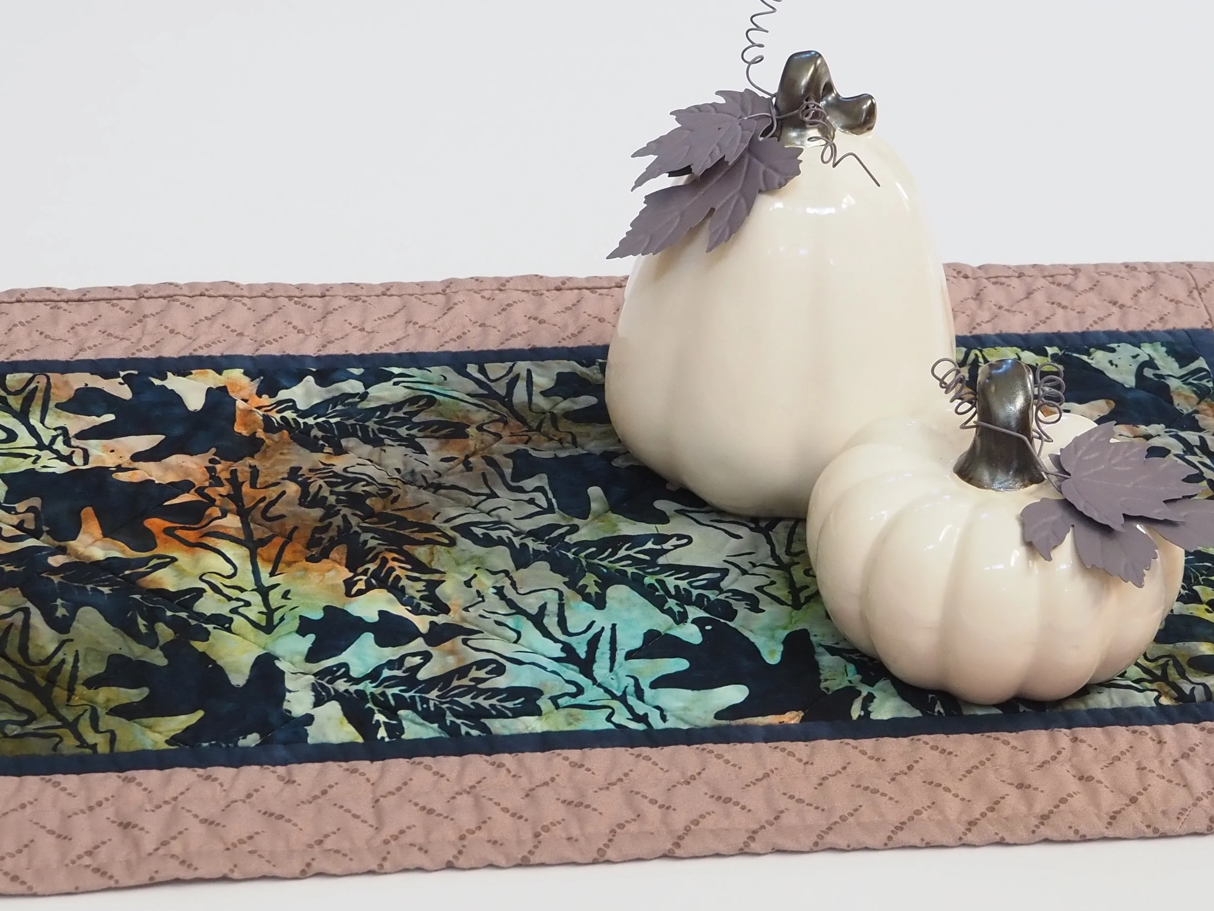 Handcrafted fall leaves batik quilted table runner on dining room table