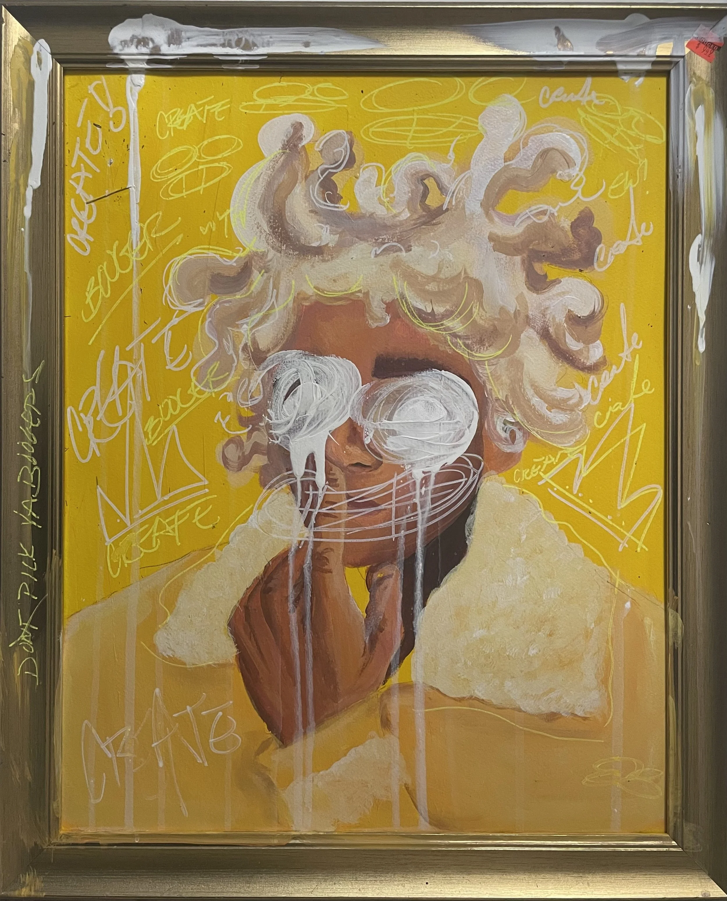 A colorful painting of a woman with curly blonde hair wearing a yellow shirt with a collar. The woman's eyes are covered with white paint splatters, and white paint drips down from her nose and chin. The background is bright yellow, with various white and yellow scribbles and tags, including words like 'create,' 'art,' and 'cafe.' The artwork is framed in a silver frame.