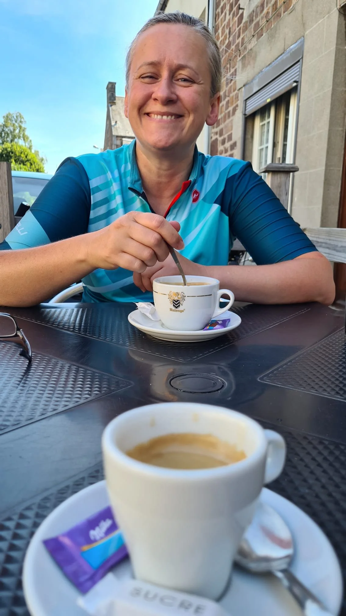 Image shows Jo drinking a coffee.