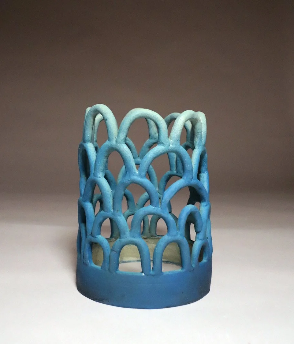 Blue decorative ceramic candle holder with arched design
