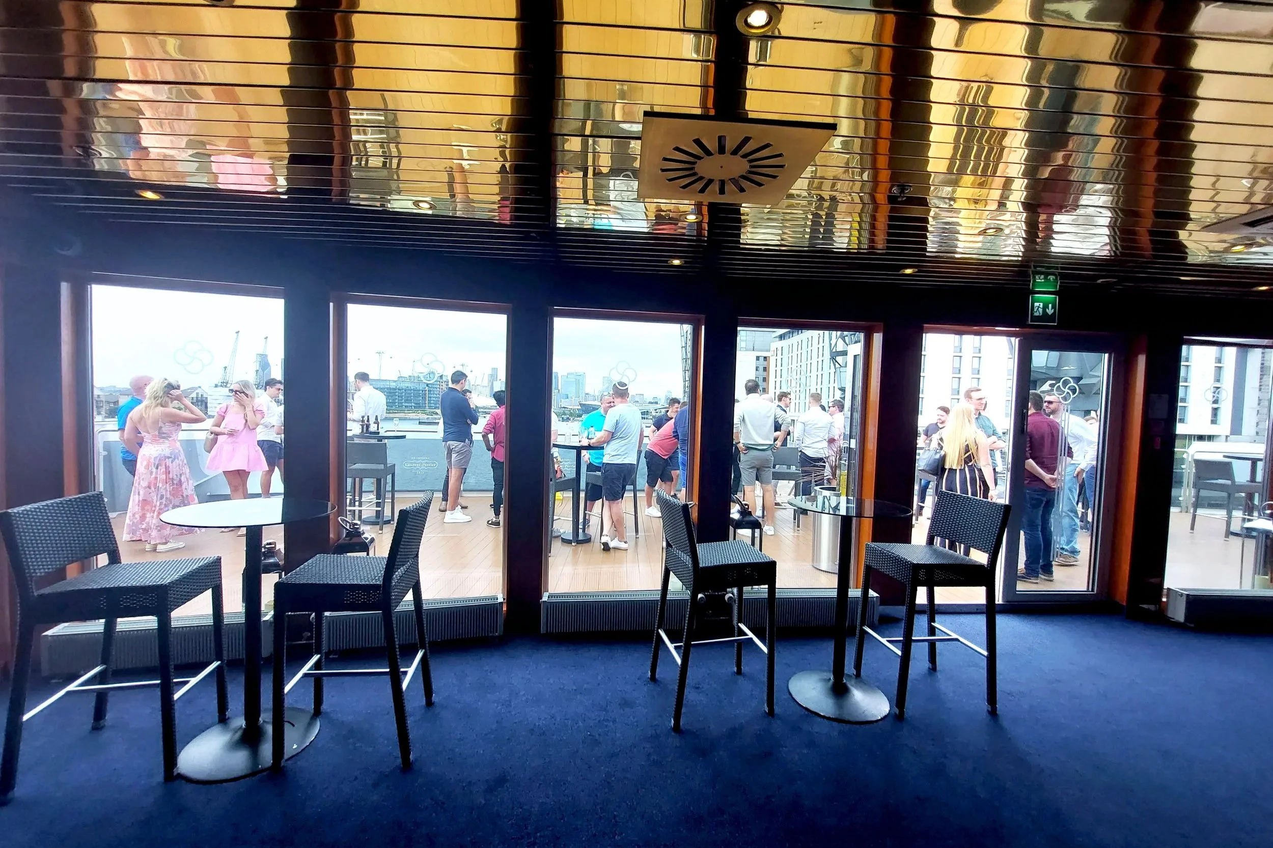 Guests moving between the yacht interior and open-air deck