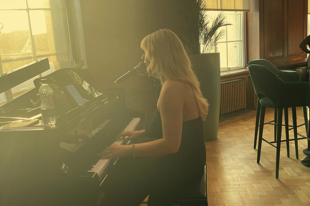 A singer performing at a piano