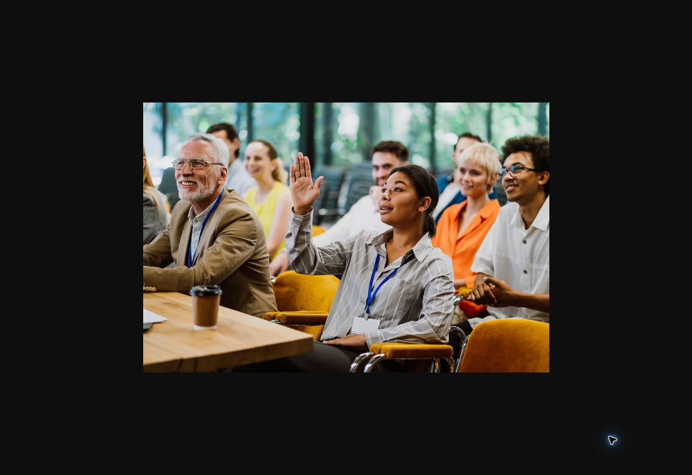 A diverse audience attending a professionally produced business conference