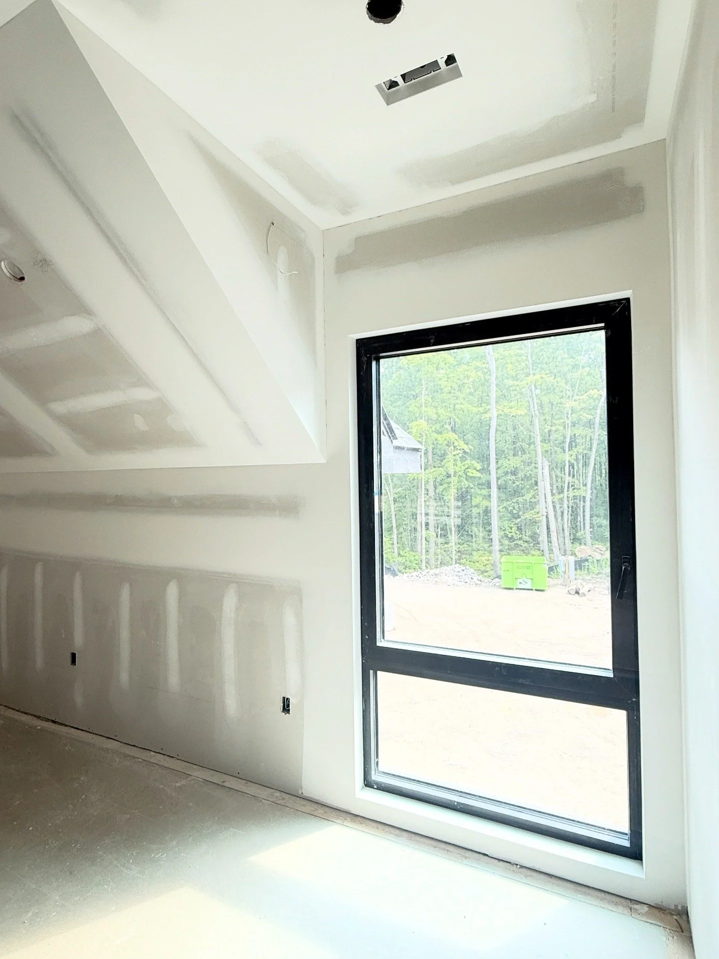 Drywall installation in progress with electrical rough-in on custom Florida build