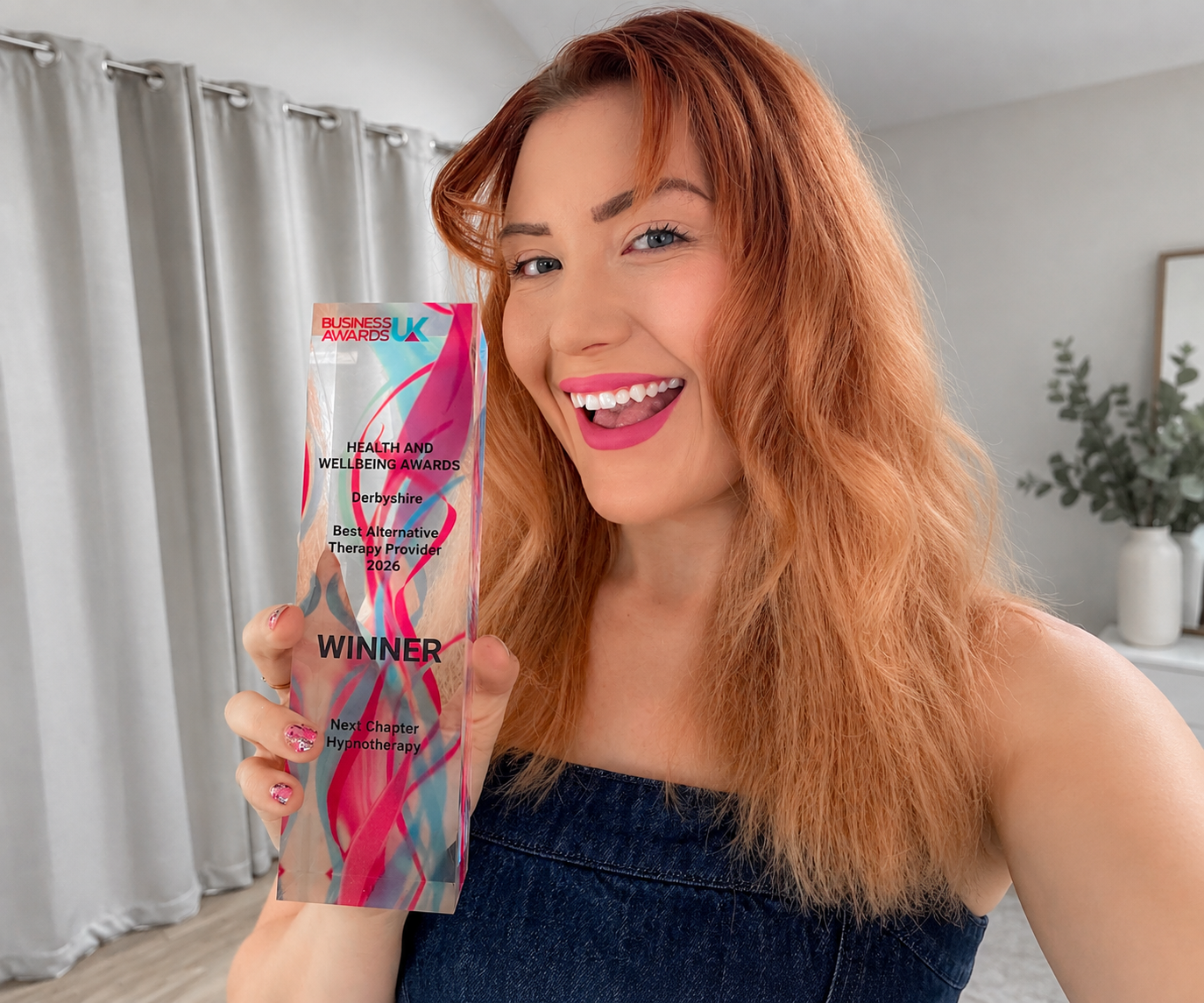 image of emma fogg owner of next chapter hypnotherapy holding the business awards uk trophy for best alternative therapy provider in the Derbyshire 2026 business awards