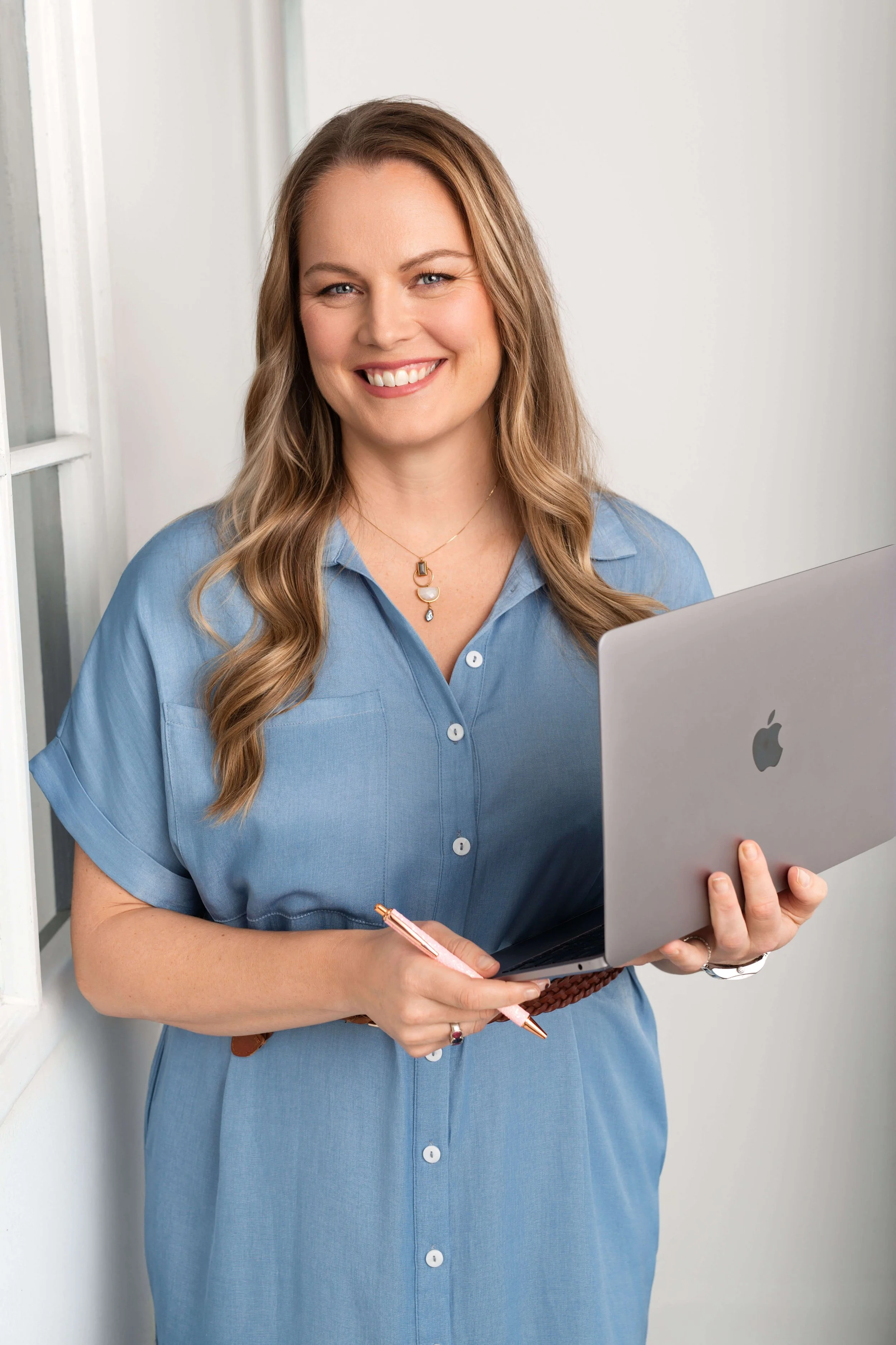 Dr Kaila Holtz, Physiatrist, holding laptop