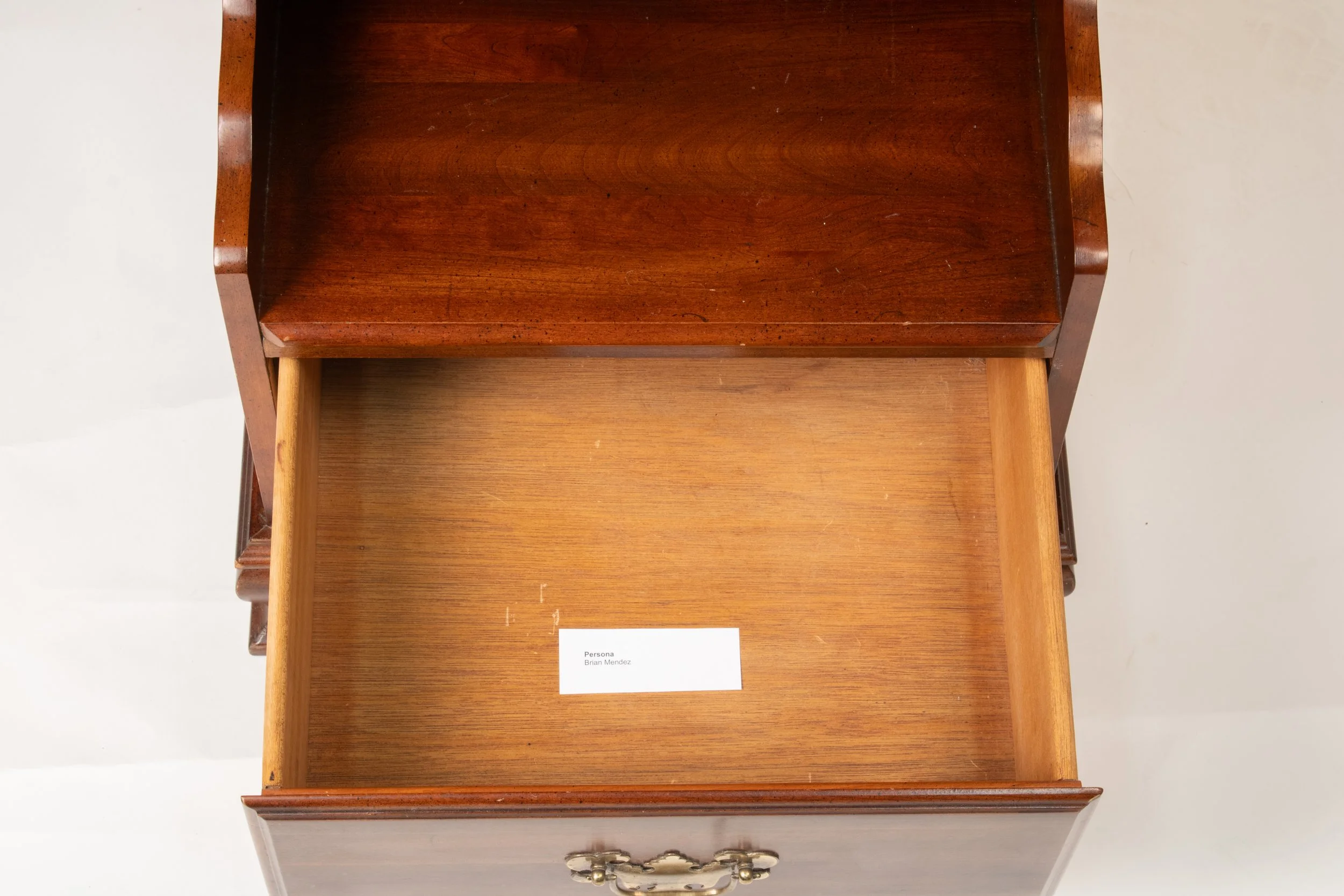 Intercambio de Fotografias entre Madre e Hijo, desde principios de Año, sobre
una Distancia de 1691.42 Kilometros. | 2025 | Interactive Sculpture | Inkjet Prints
and Found Furniture