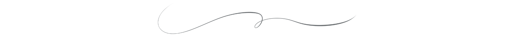 A decorative black and white sign with cursive writing that says "Grand Opening".
