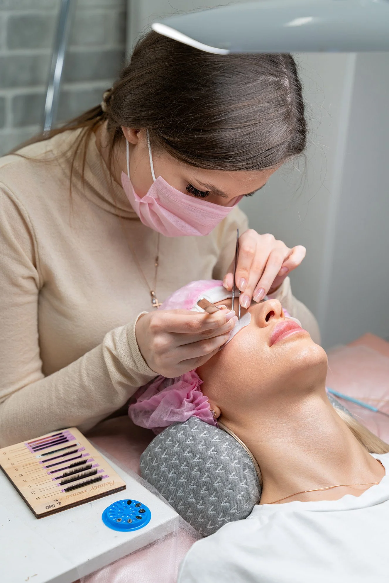 Luxury eyelash extension service at Pink Élan Lash in New York City, client receiving professional lash treatment in studio