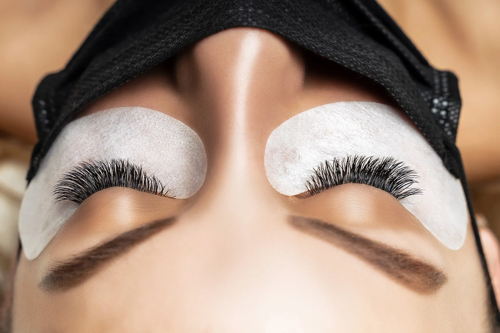 Client receiving luxury eyelash extension service at Pink Élan Lash NYC, relaxing lash appointment in a professional lash studio