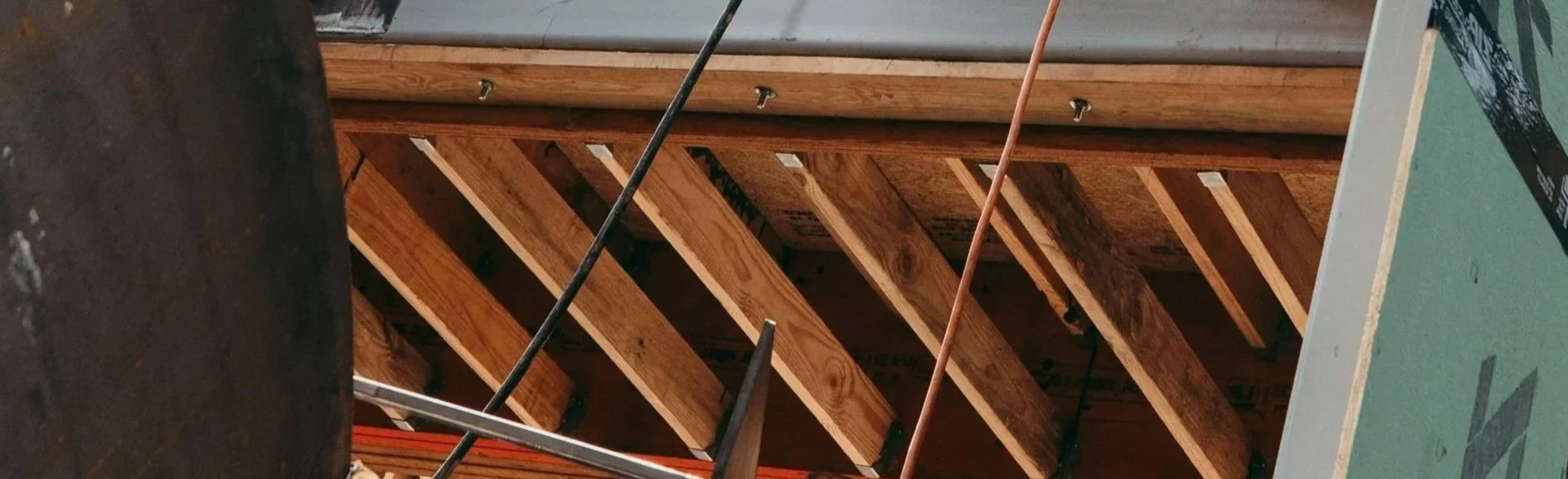 Construction site with wooden framing and metal support beams.
