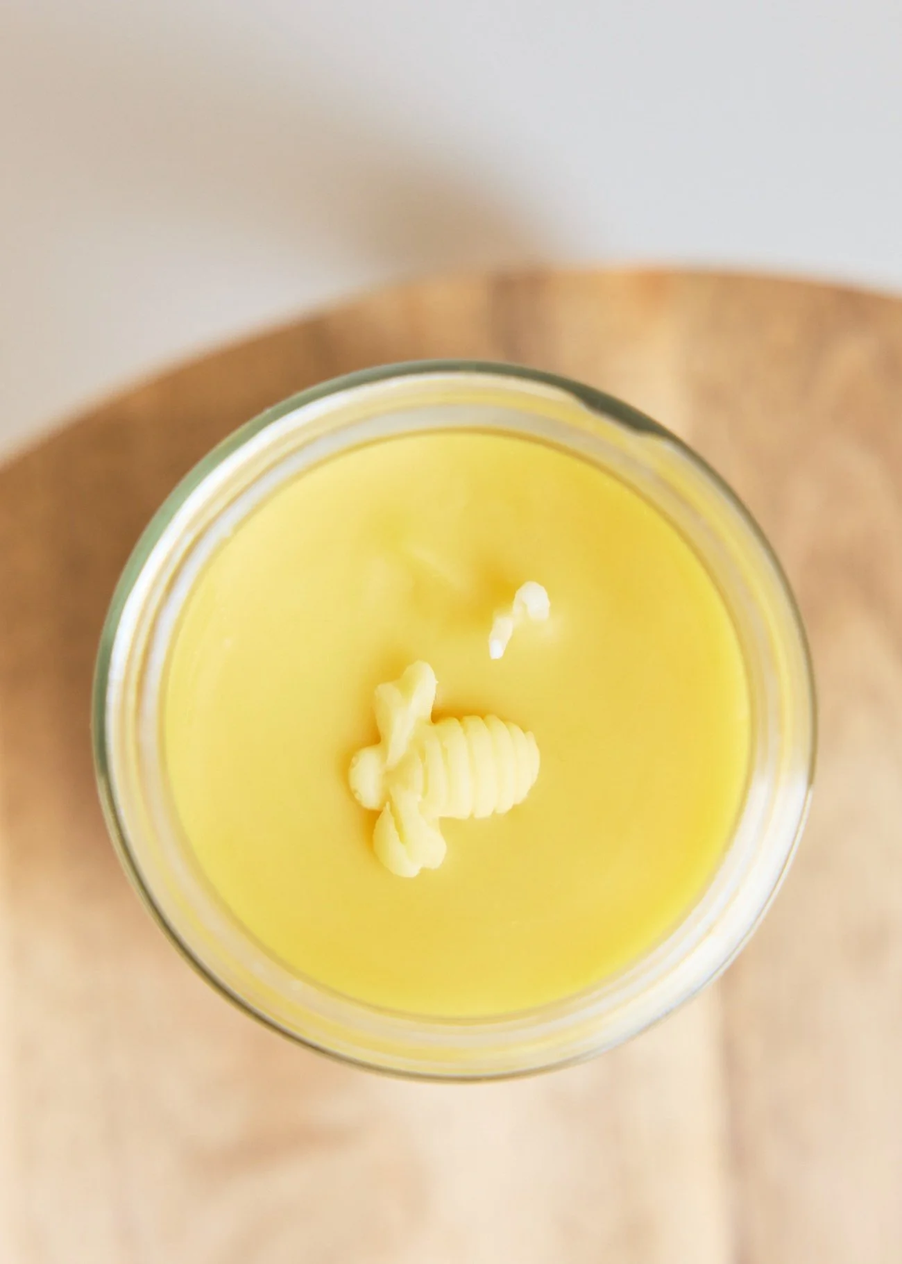 Top of a yellow candle with a bee shaped wick.
