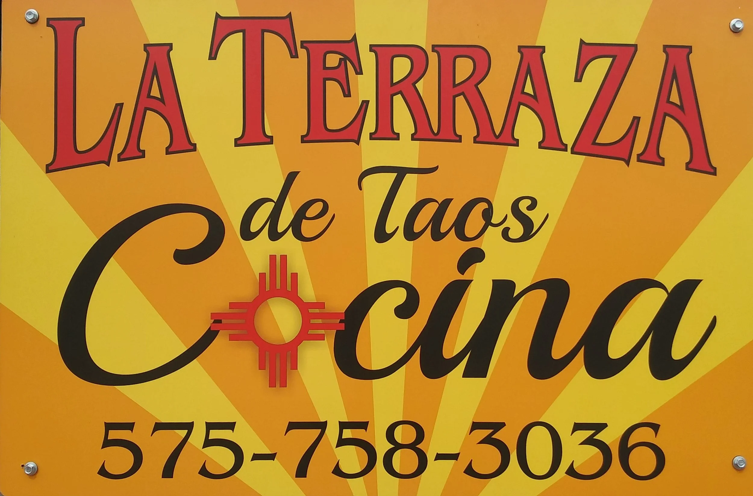 Sign for La Terraza de Taos Cocina, with a yellow and orange background, featuring a red and black logo and the phone number 575-758-3036.