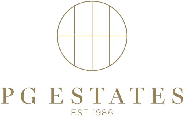 Logo with a gold circular grid above the text 'PG ESTATES' and 'EST 1986' beneath, indicating a real estate company.