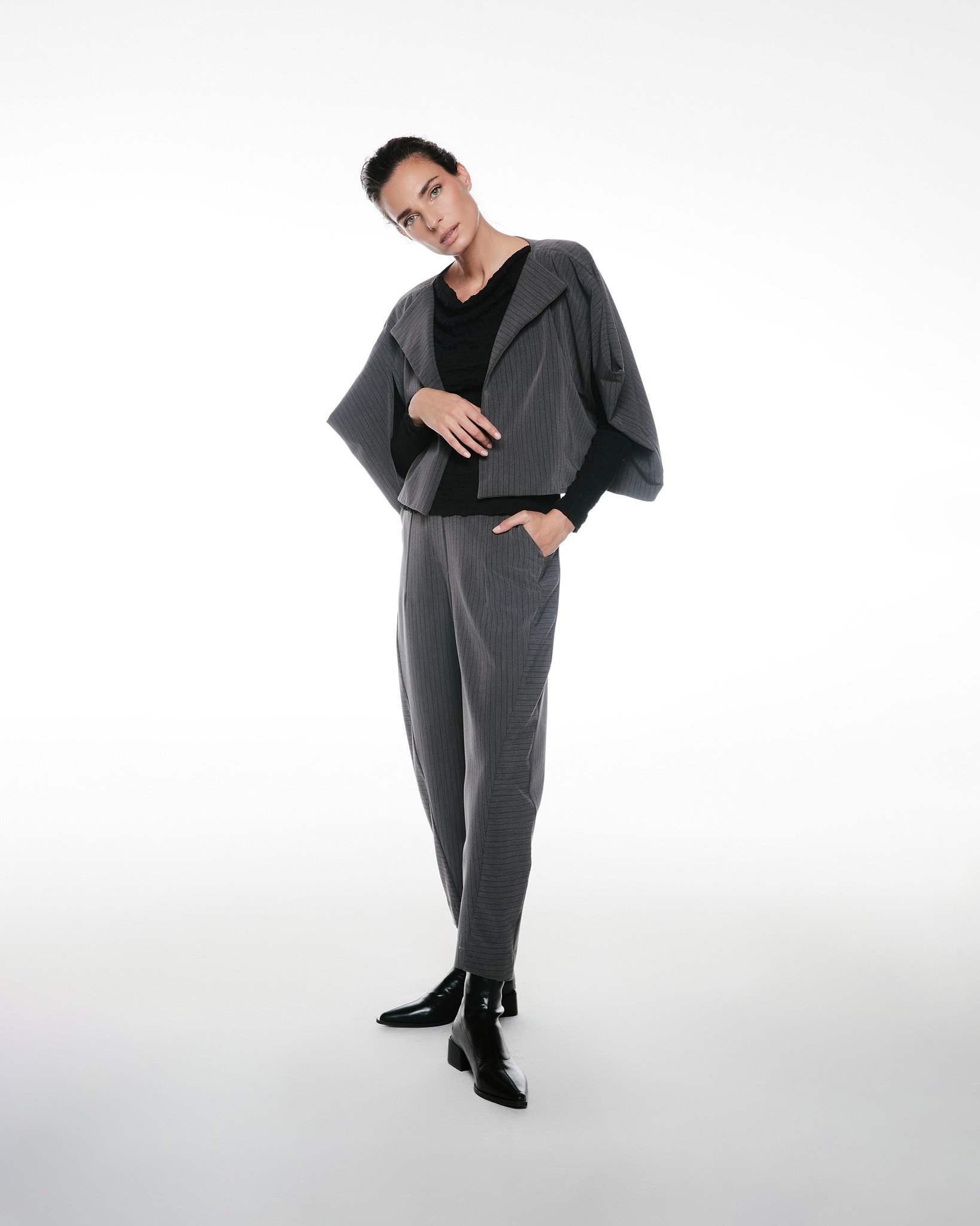 Featuring: Coat Violet

Coat Violet showcases a sculptural cropped silhouette with fluid lines that frame the body with quiet confidence.

Layered over a sleek base and paired with tailored trousers, it transforms even the simplest outfit into a refi