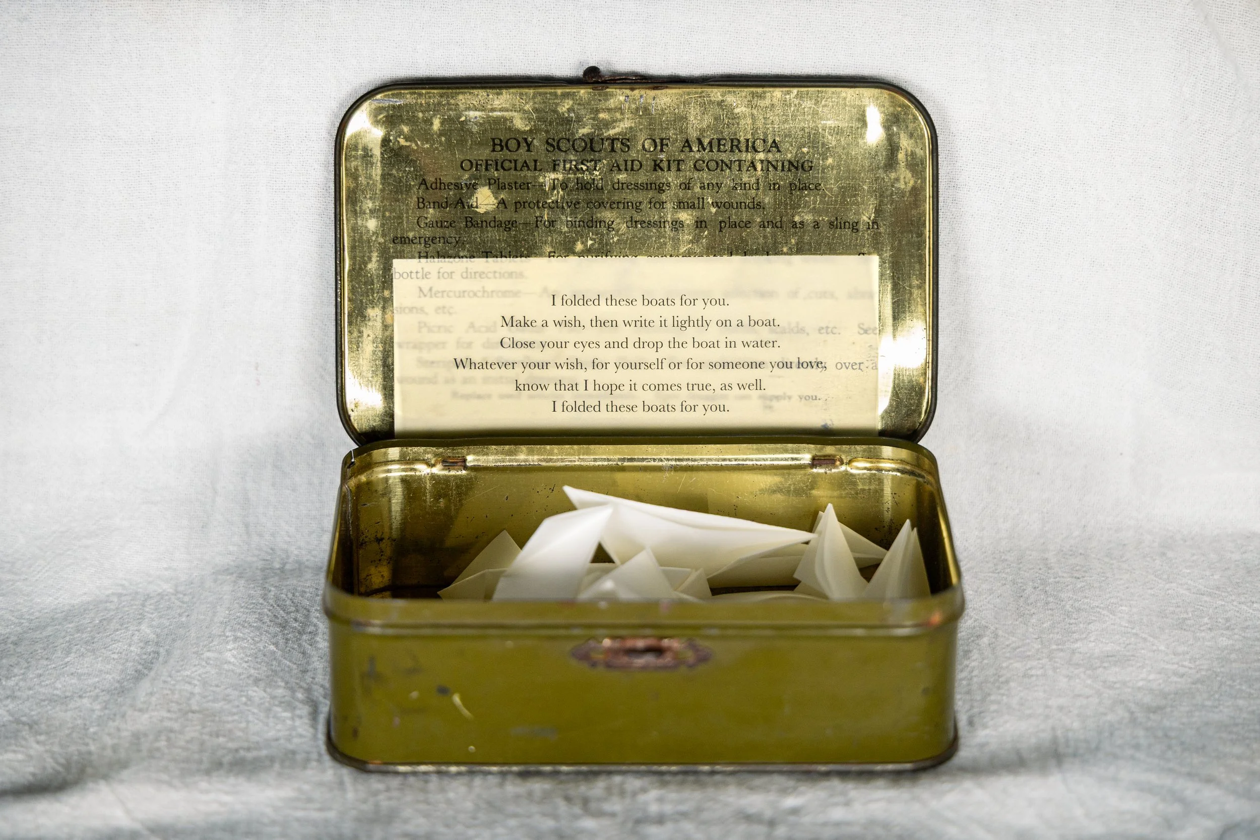 Inside, instructions for performing the piece and several origami boats.