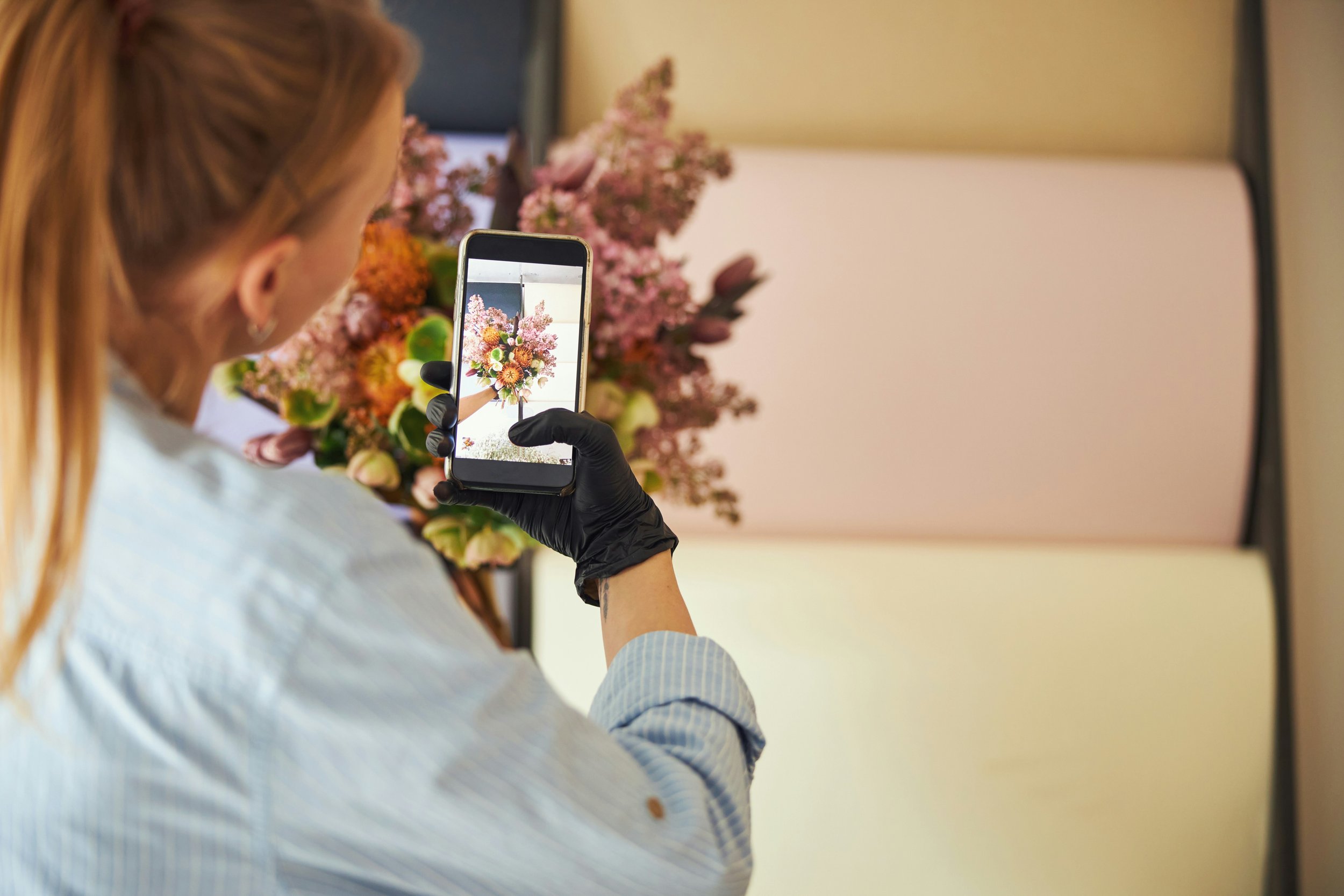 Creator taking photo of flowers for social media