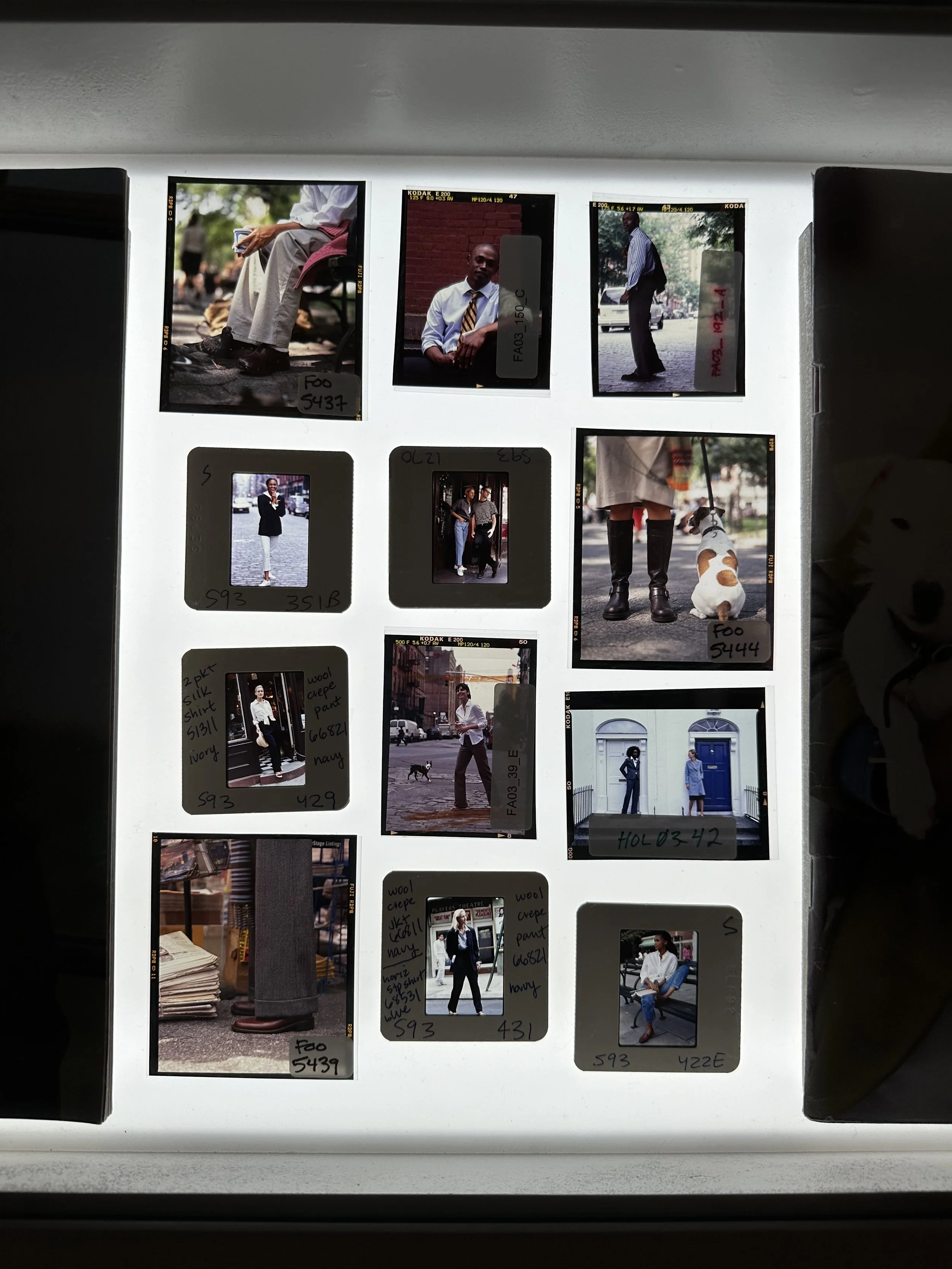 A collection of 12 film photographs featuring people, with some notes and codes written on the white frame surrounding the images.