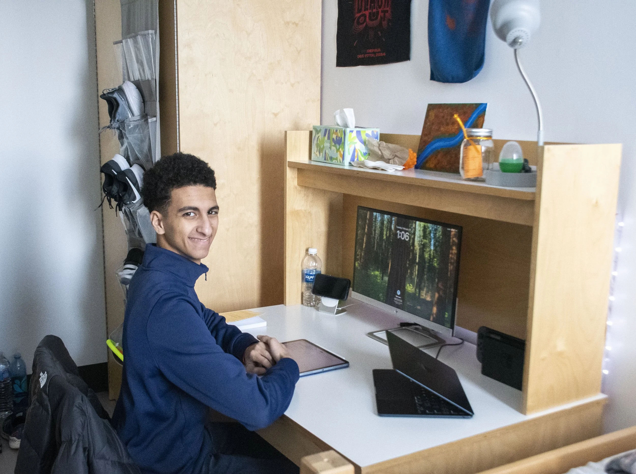 Noah's friend Elyas posing at his desk