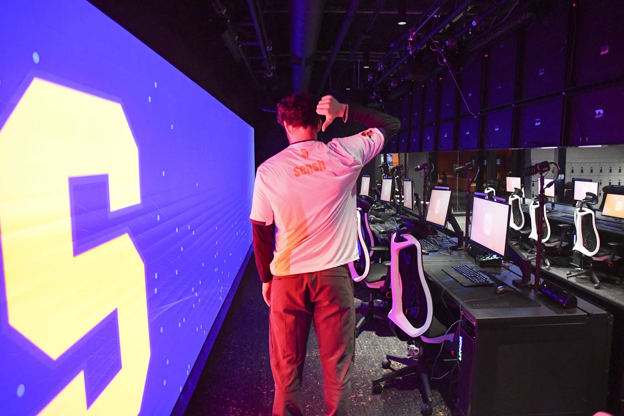 Anthony Soly points to his nickname on the back of his jersey.