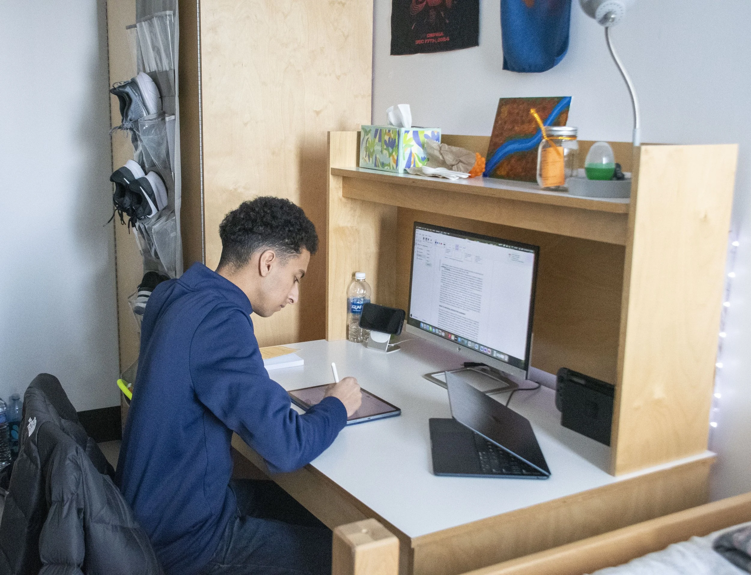 Noah's friend Elyas working at his desk