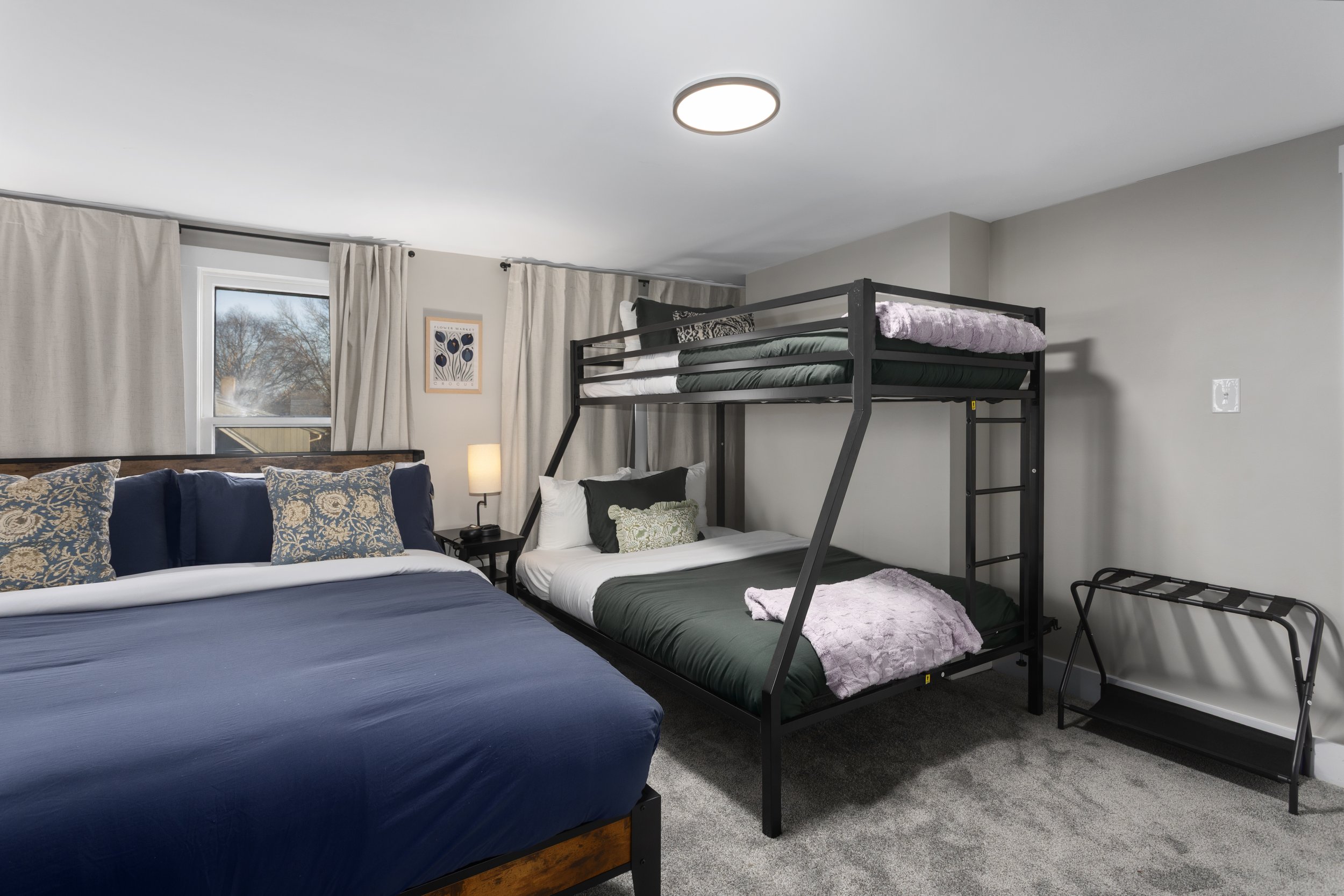 Bedroom with queen bed and bunk beds