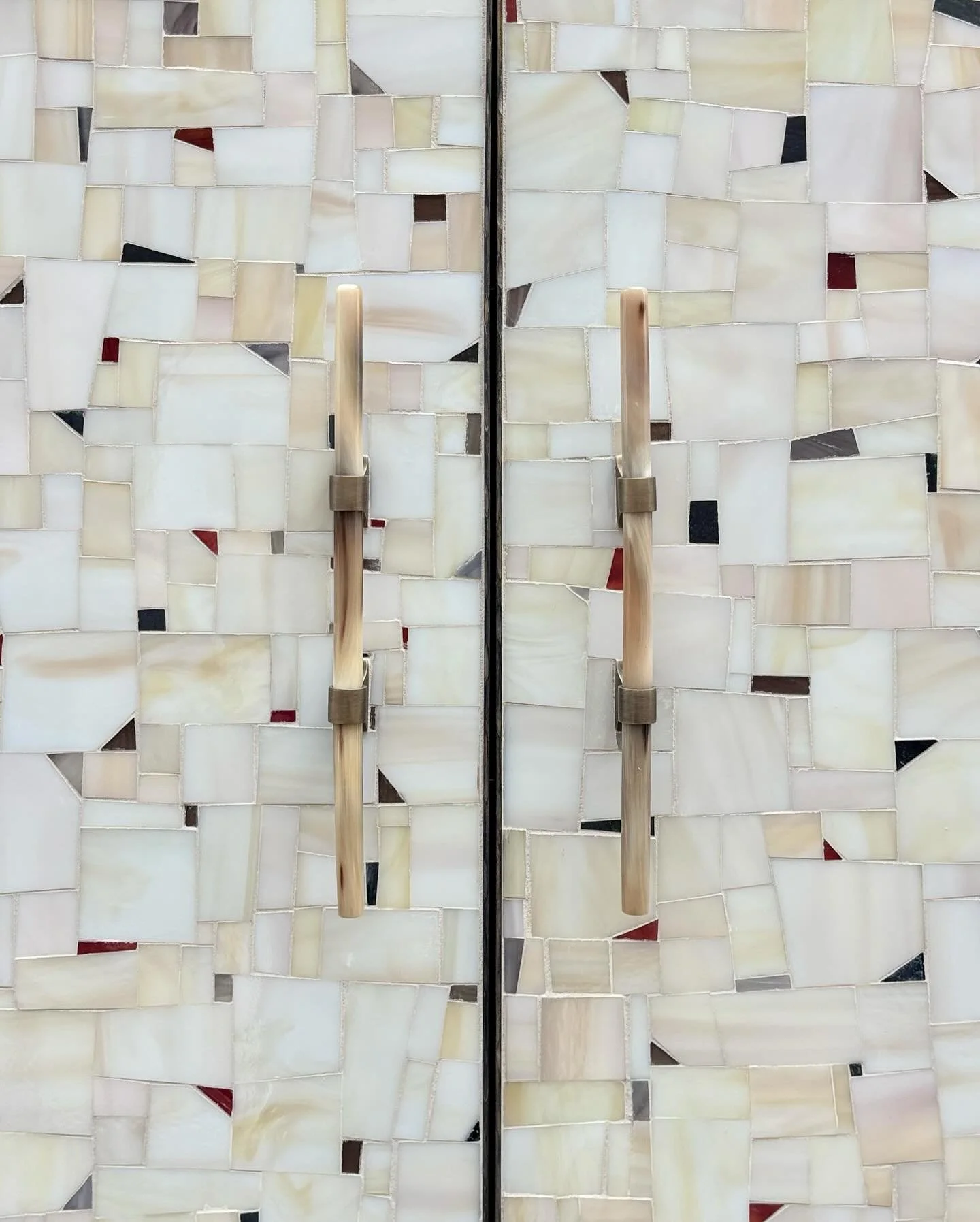 chelsea two door terrazzo armoire in oak with birnjal finish, terrazzo mosaic in light ivory, wispy taupe silver, black/silvered, and terracotta, and horn handles

for Katy eppley design