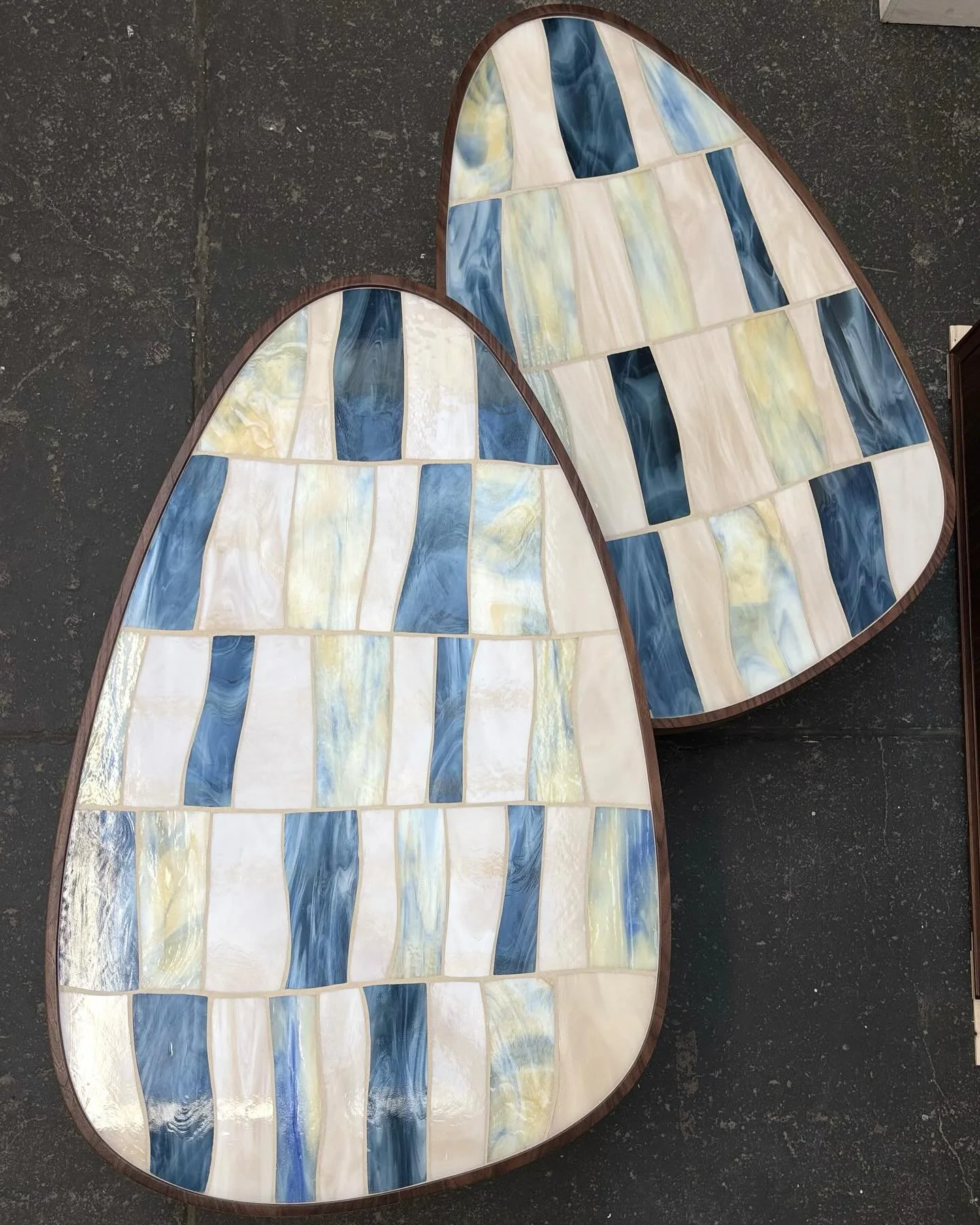 a pair of nesting palazzo coffee tables with hand-cut mosaic in shades of sandy ocean, vintage jeans, and sand glass