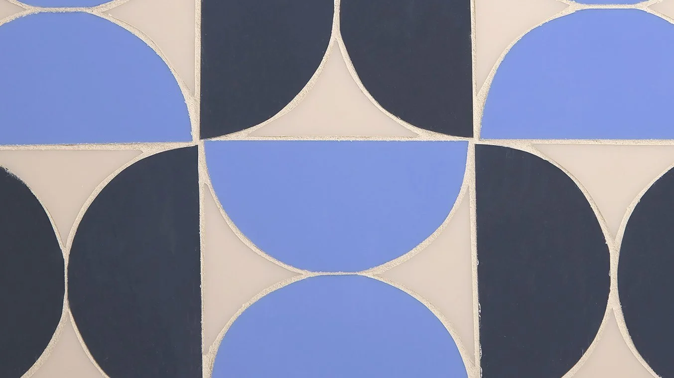 A geometric pattern of circles and squares in black, white, and blue colors.