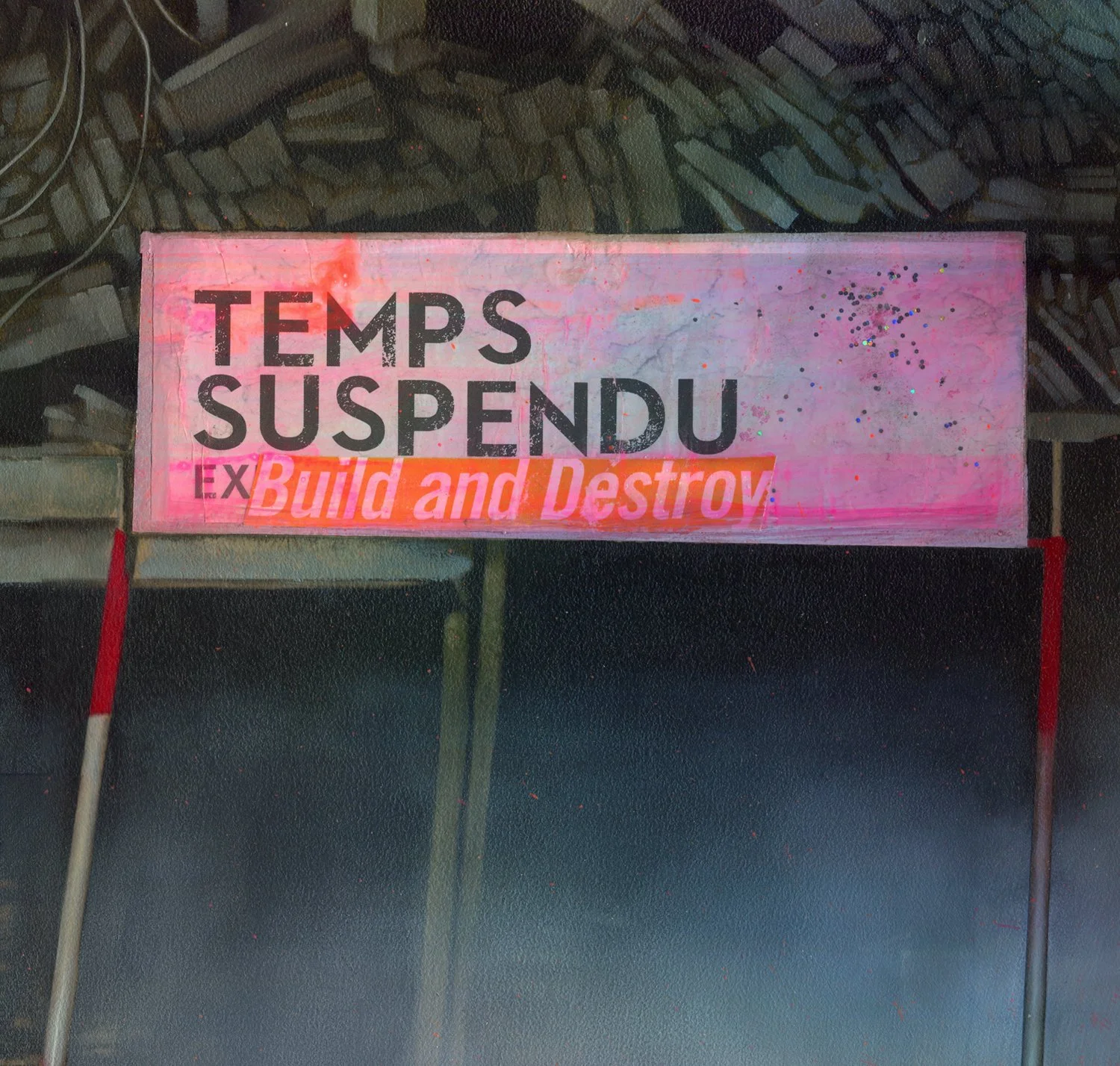 A protest sign with the message 'Temps Suspendu' and 'Build and Destroy' in bright colors and bold fonts, set against a background of a rough, dark surface.
