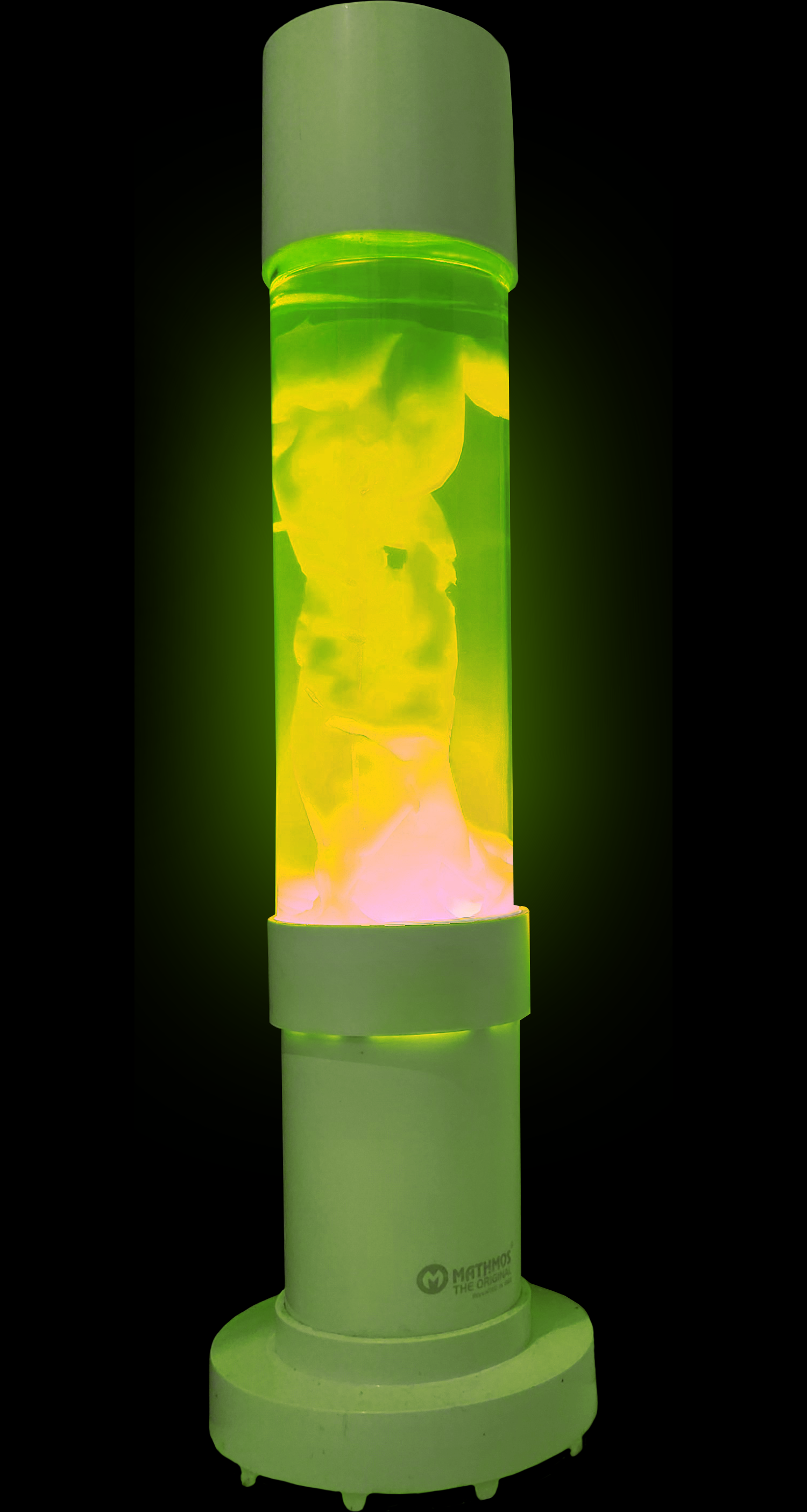A cylindrical device with a glass-like container filled with yellow and pinkish glowing substances. The device is labeled 'Mathmos' and appears to be a lava lamp or artistic light sculpture with a bright glow.