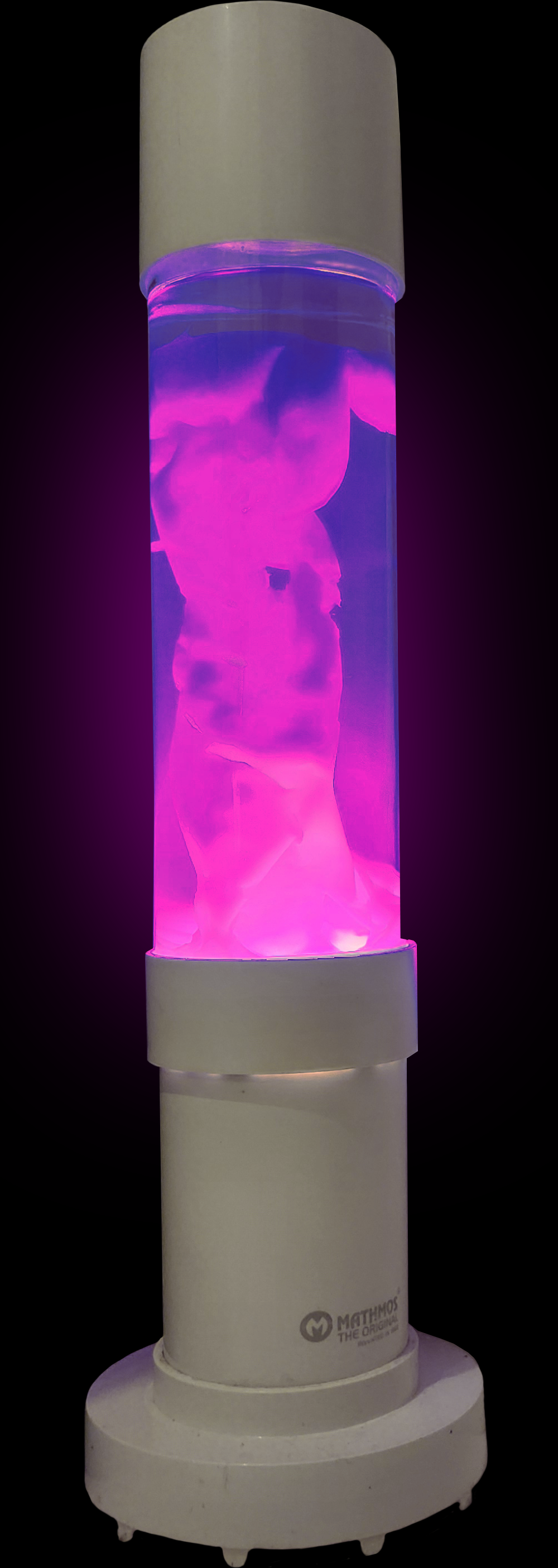 A cylindrical lava lamp with pink and purple swirling wax inside, illuminated against a dark background.