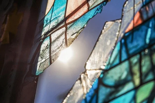 sunshine coming in through a cracked stained glass window