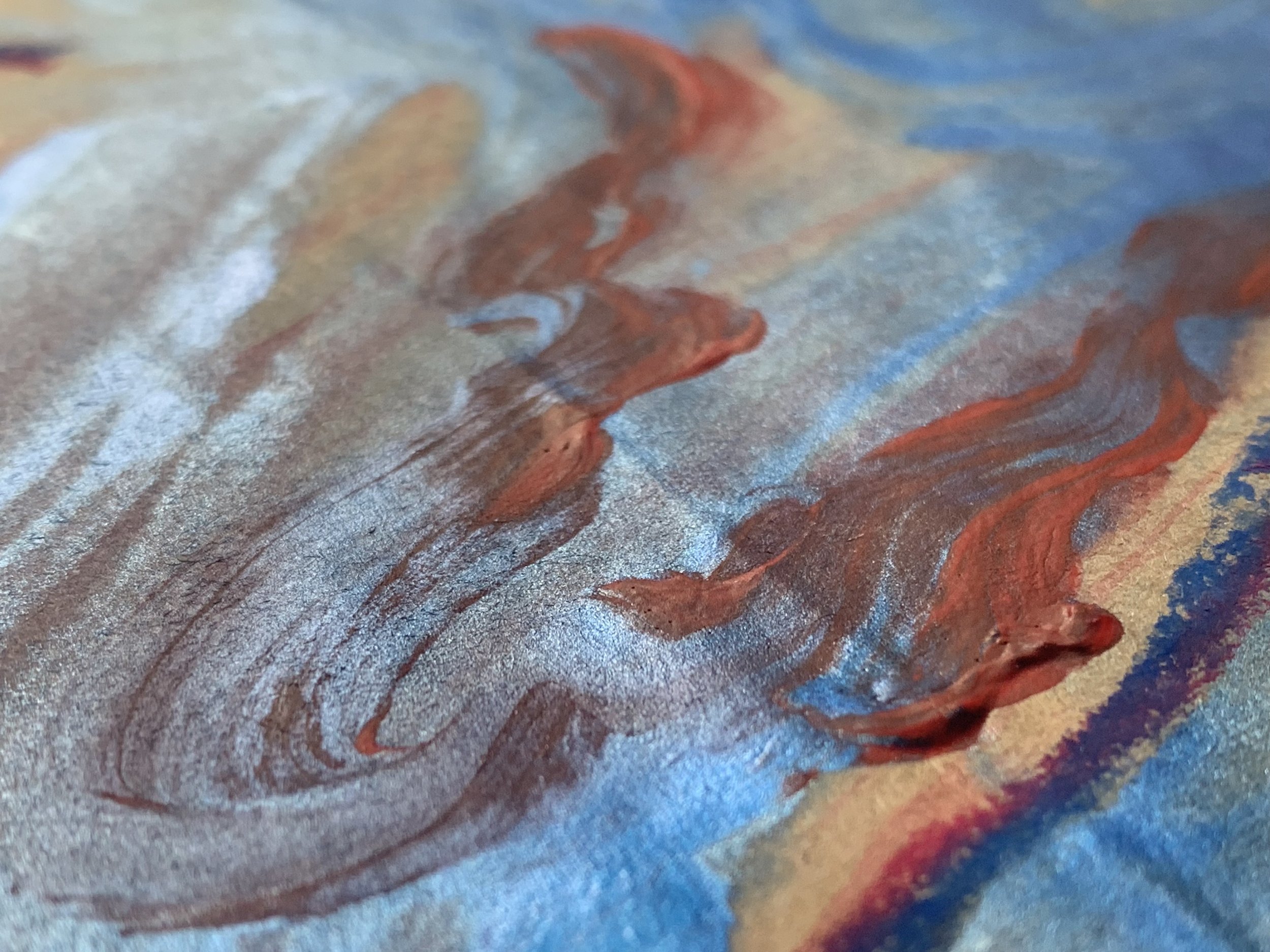 Close-up of an abstract painting with swirling blue, beige, and red colors and textured brushstrokes.