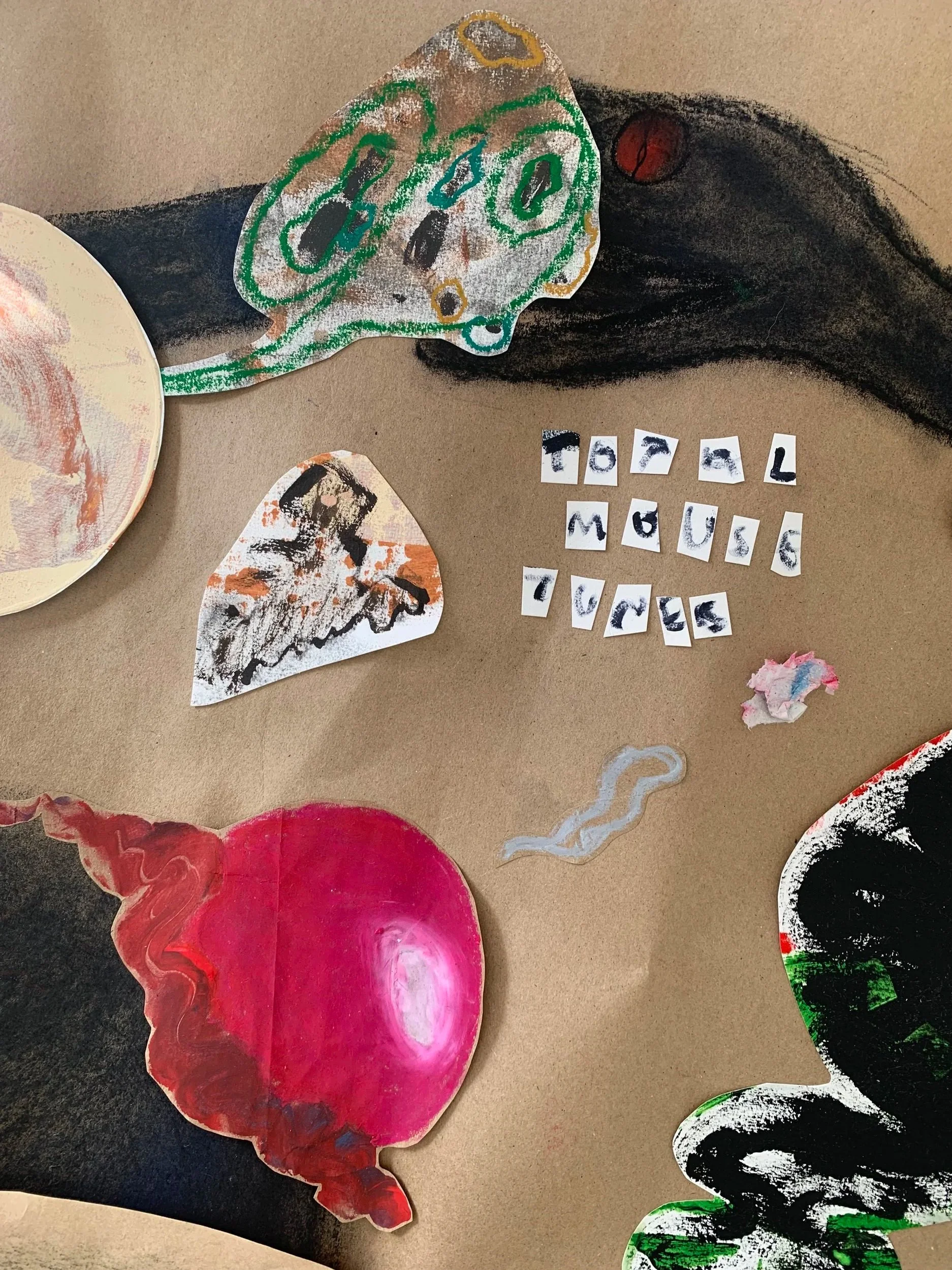 Colorful, abstract illustrations of a mouse, a tail, and a head, with the words 'total mouse tunes' spelled out in cut-out letters on a brown background.