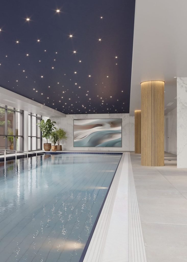 Indoor swimming pool with a dark ceiling embedded with small star-like lights, large windows on the left side, a beige marble wall with green potted plants, a large abstract painting on the back wall, and wooden columns.
