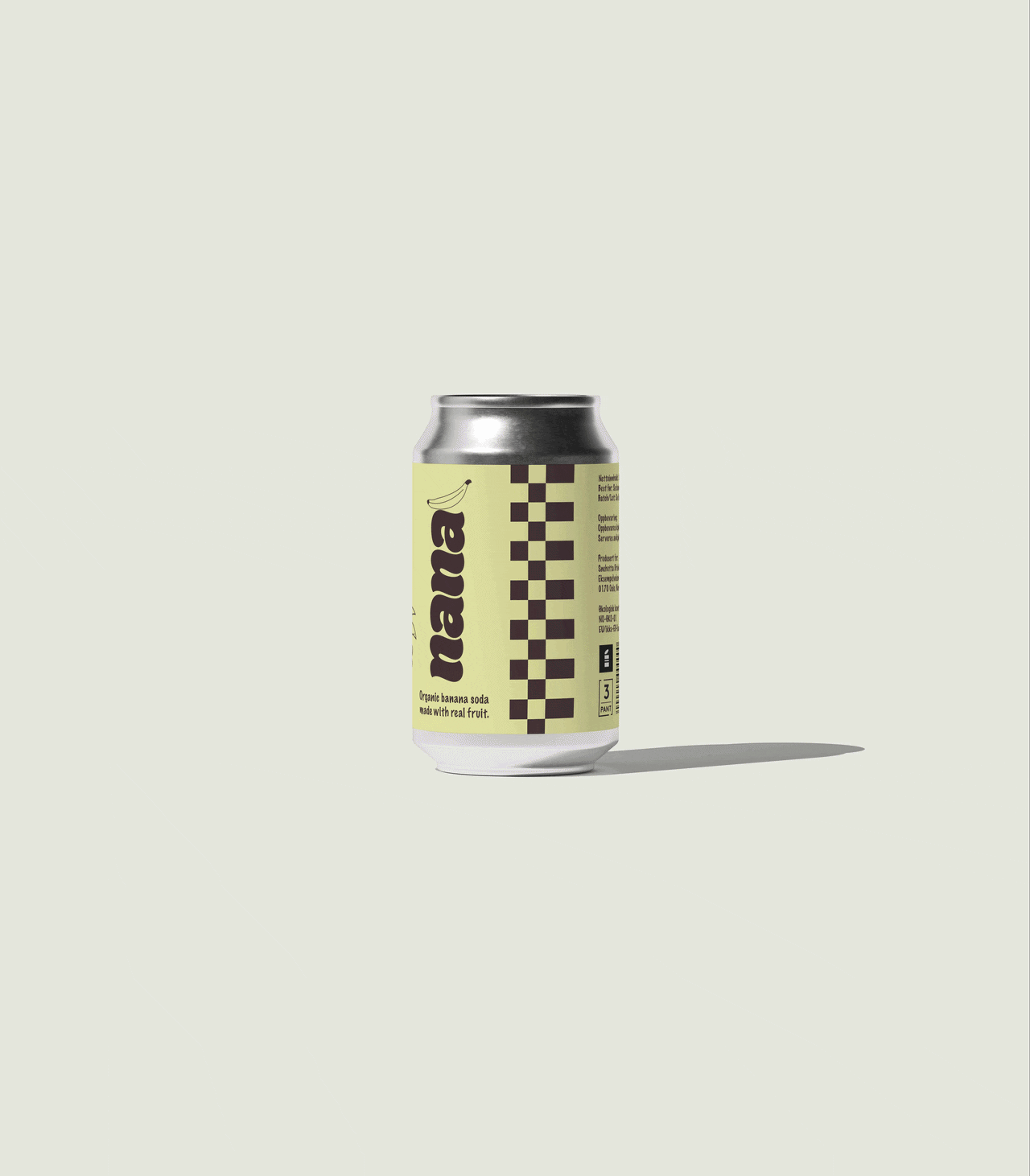 A can of organic banana soda with a pale yellow label, black and white checkered pattern, and the word "na" visible on the label, placed on a plain light background.