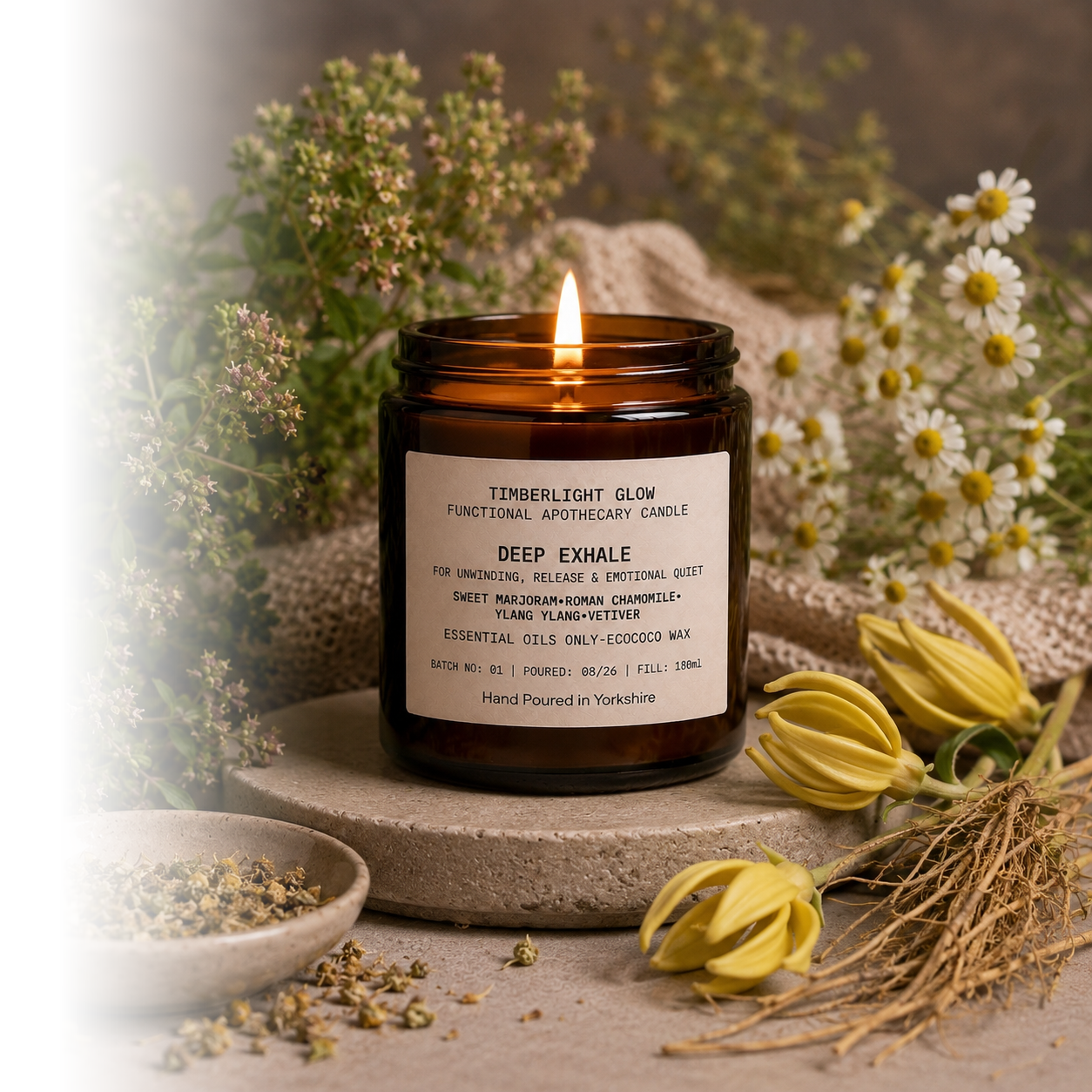 Lit TimberLight Glow Deep Exhale functional apothecary candle in an amber glass jar.