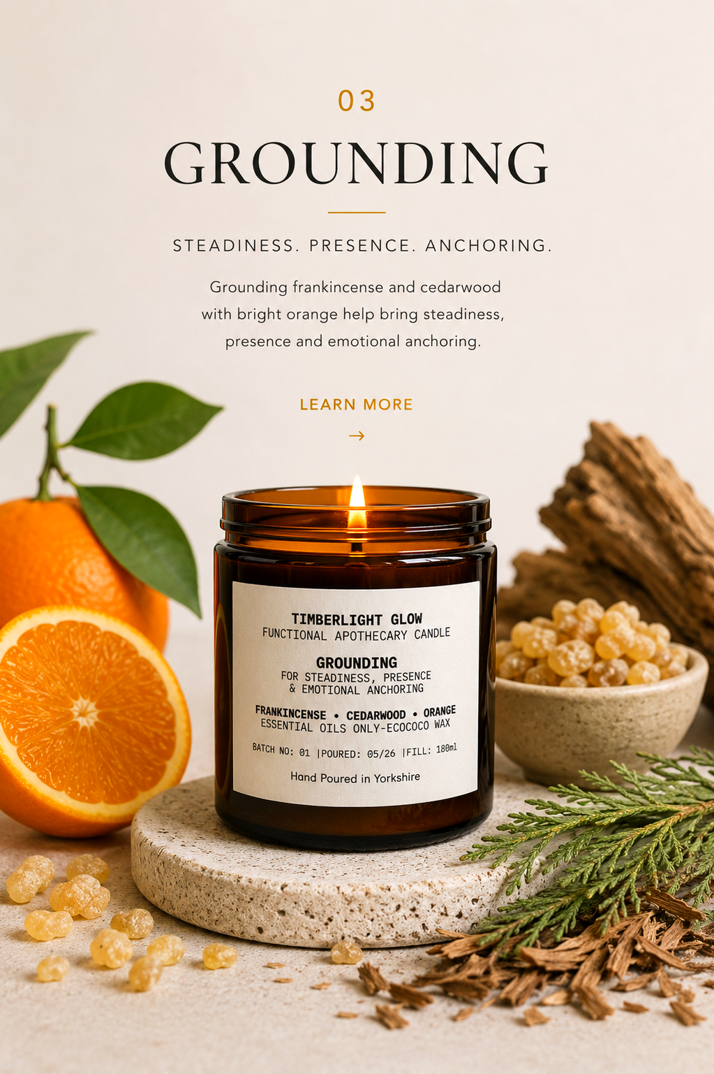 Lit TimberLight Glow Grounding aromatherapy candle displayed with cedarwood, frankincense resin and sweet orange botanicals.