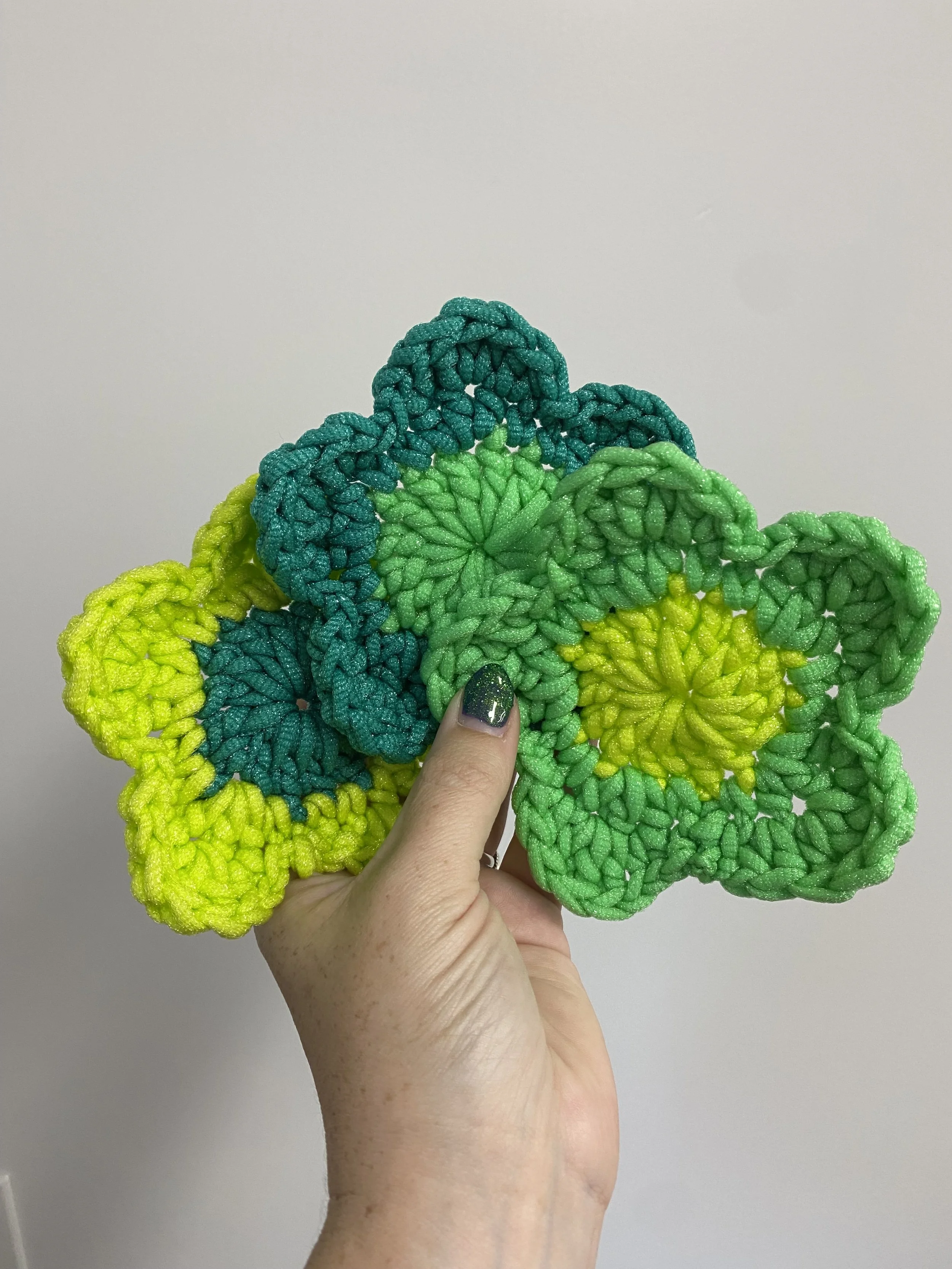 multiple green colored flower shaped dish scrubbier, crocheted