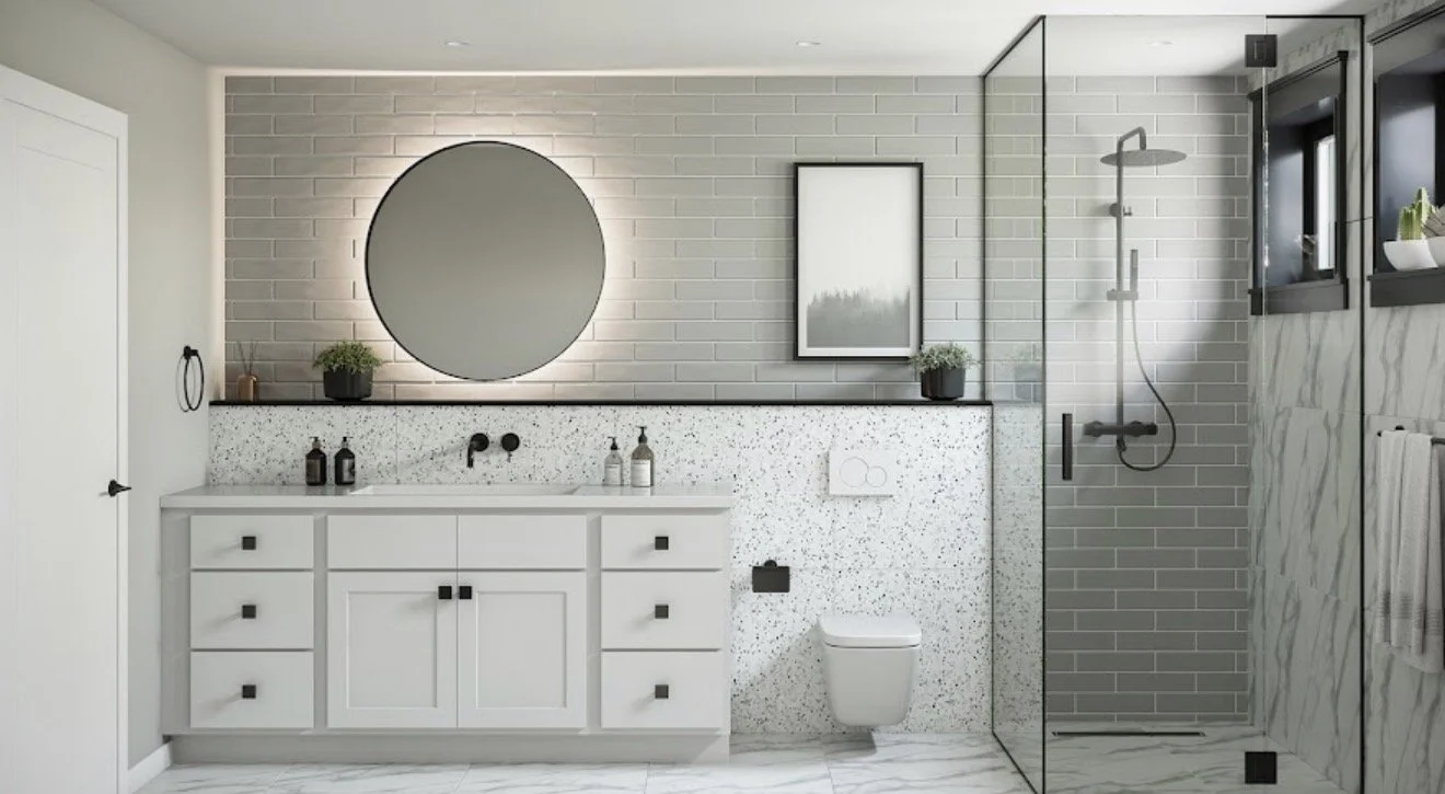 Modern bathroom with white vanity, round mirror, grey brick wall, framed artwork, potted plants, glass shower enclosure, grey subway tiles, and white marble wall.
