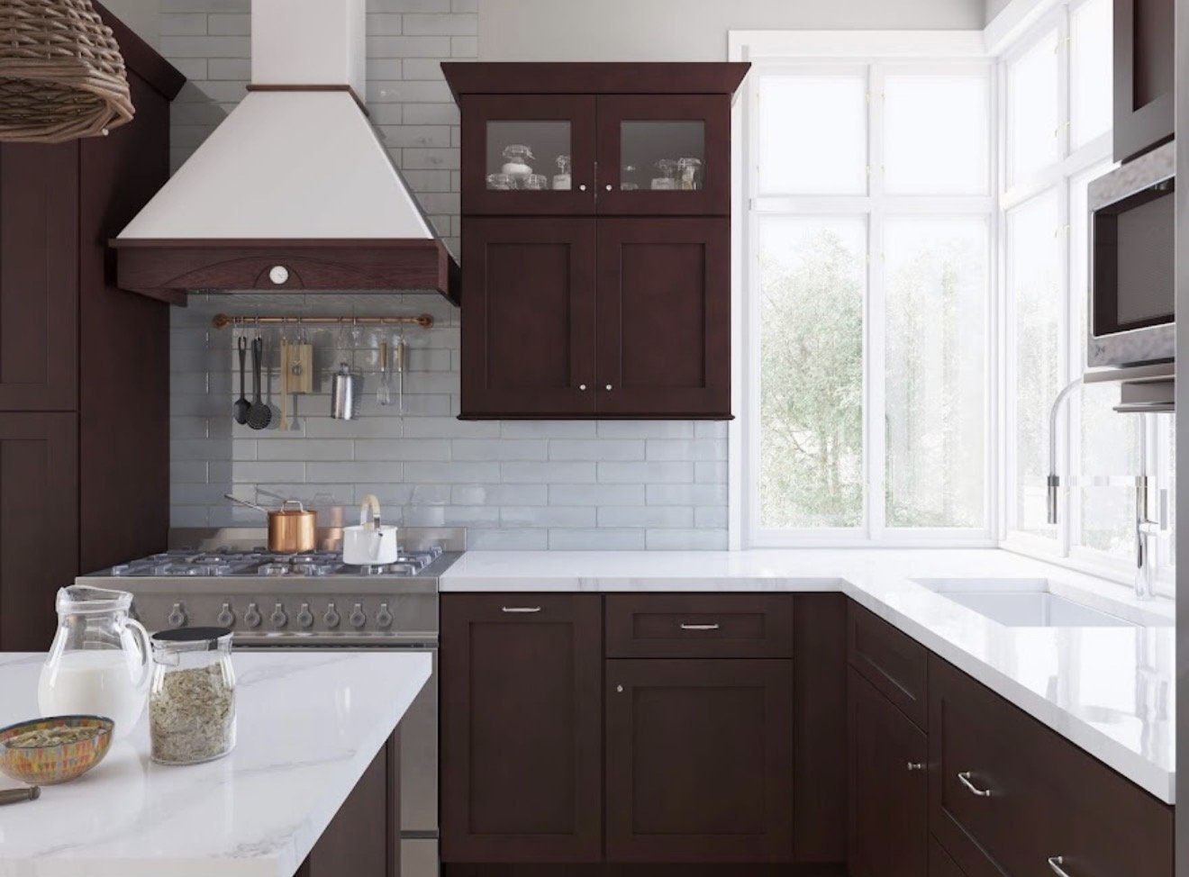 Modern kitchen with white countertops, dark wooden cabinets, a gas stove, a white vent hood, and a large window letting in natural light.