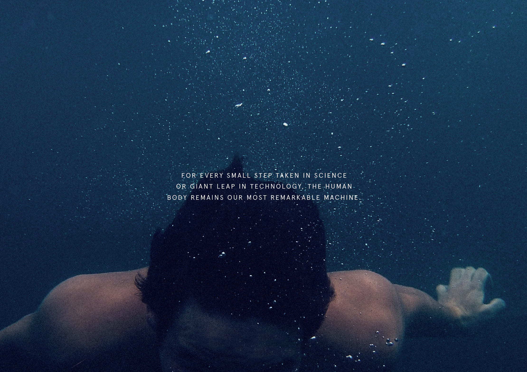 A person swimming underwater with waves creating bubbles around them, and a quote in the center about science, technology, and the human body.